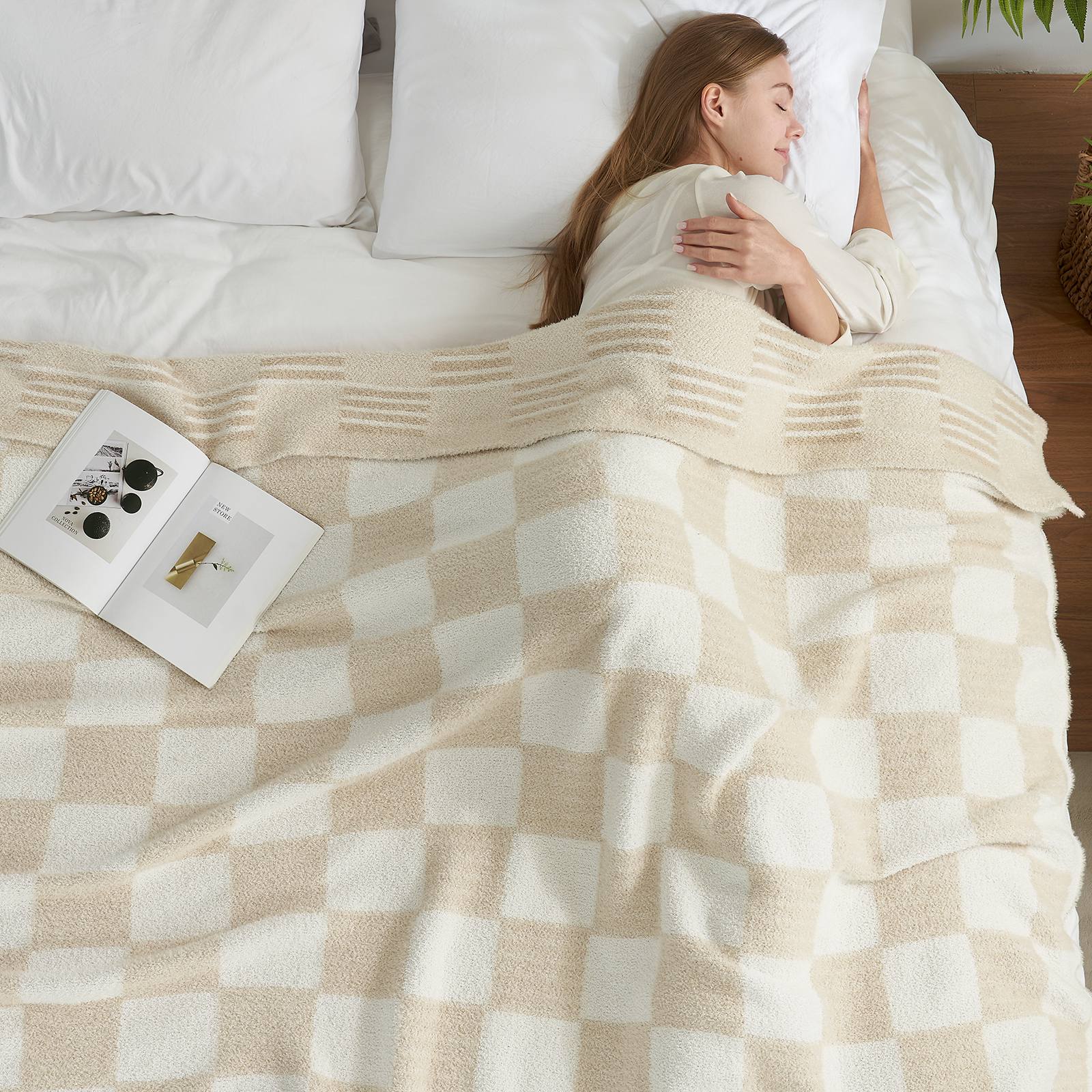 A woman laying on bed with Snuggle Sacs Reversible Heather Checkered Feather Yarn Knit Throw Blanket and a magazine #Color_Heather Cream