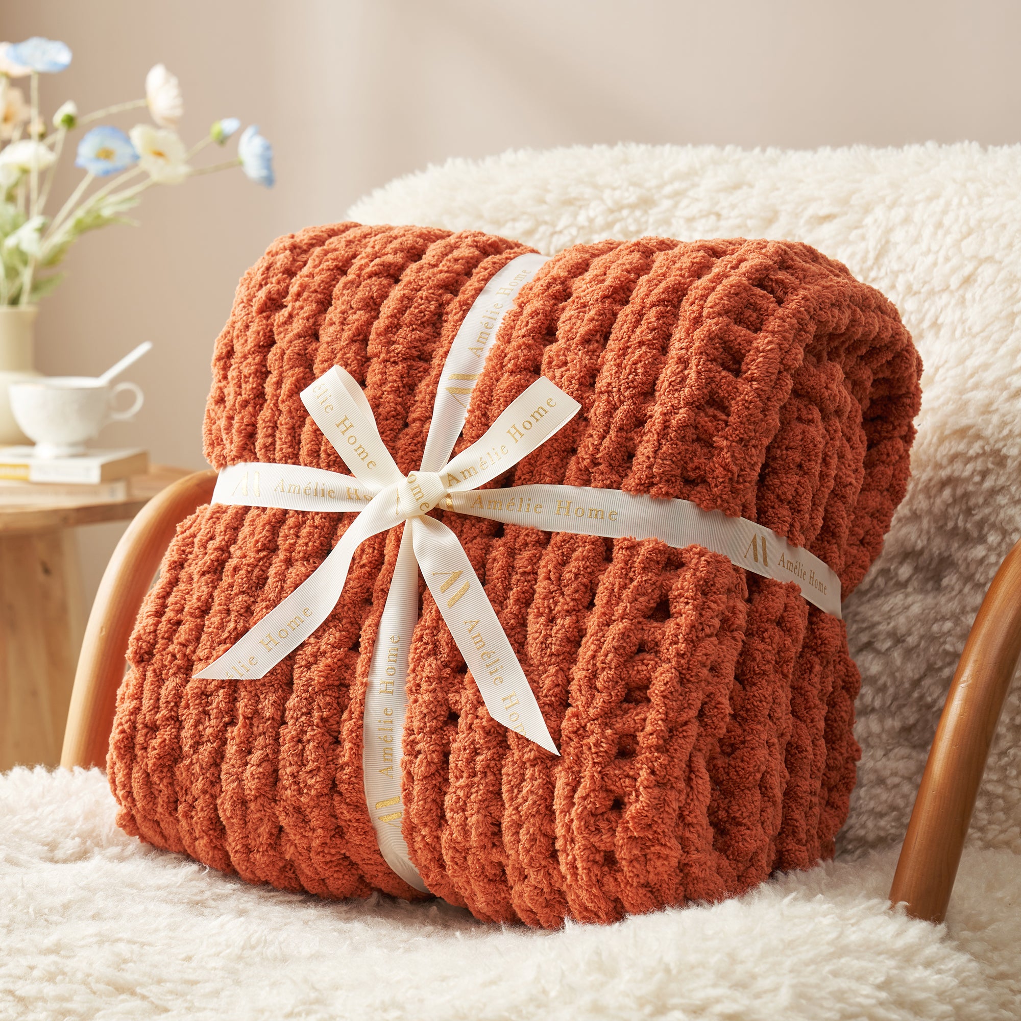 Rolled chunky knit throw blanket in Burnt Orange with ribbon showcasing plush texture #color_Burnt Orange