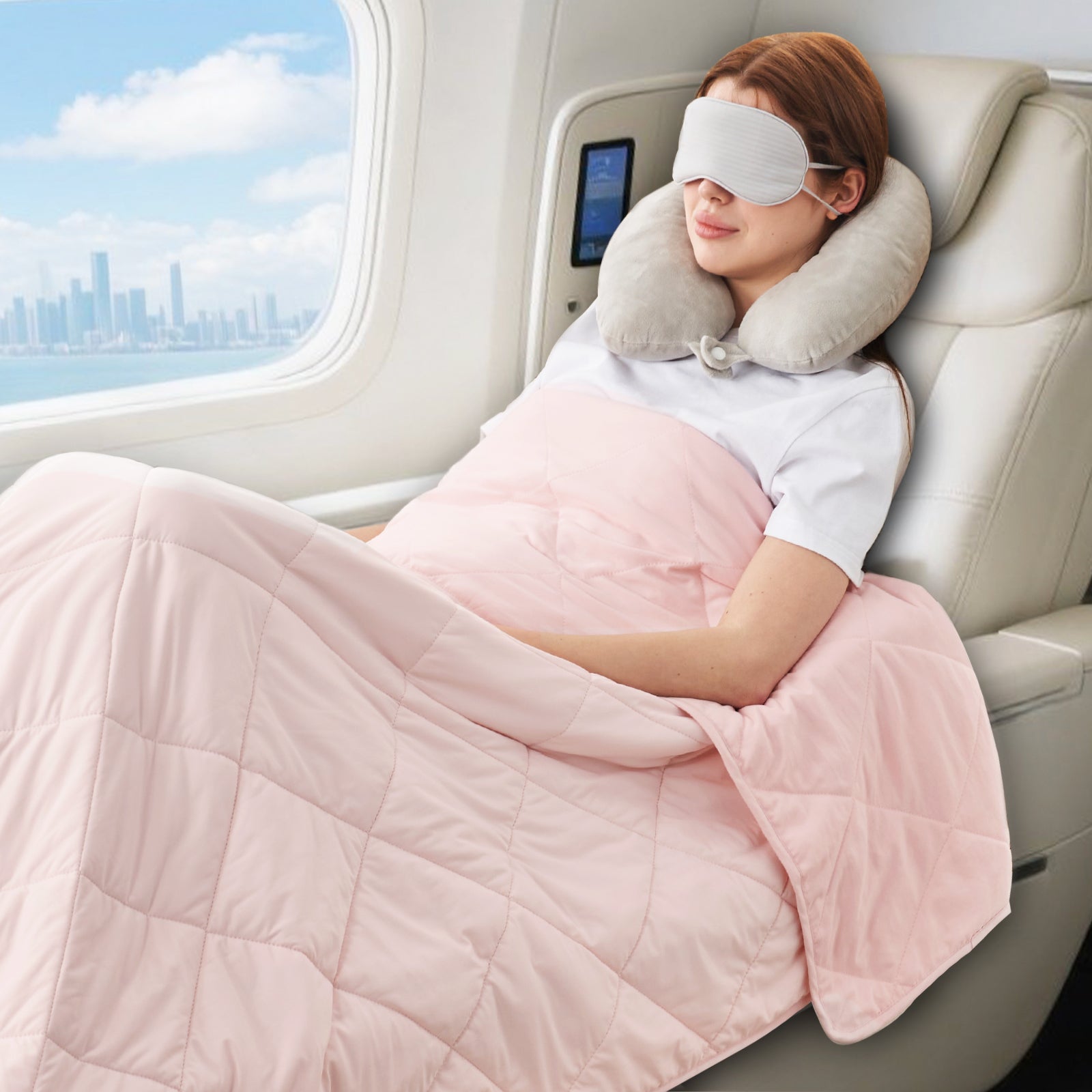 Women sleeping on an airplane with a neck pillow and Snuggle Sac pink blanket.#color_Pink