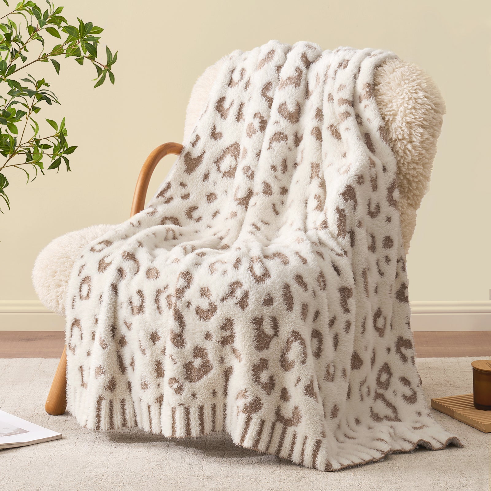Snuggle Sac leopard faux fur knit throw blanket in Leopard Beige draped over an armchair, creating a cozy and stylish living corner #color_Leopard Beige