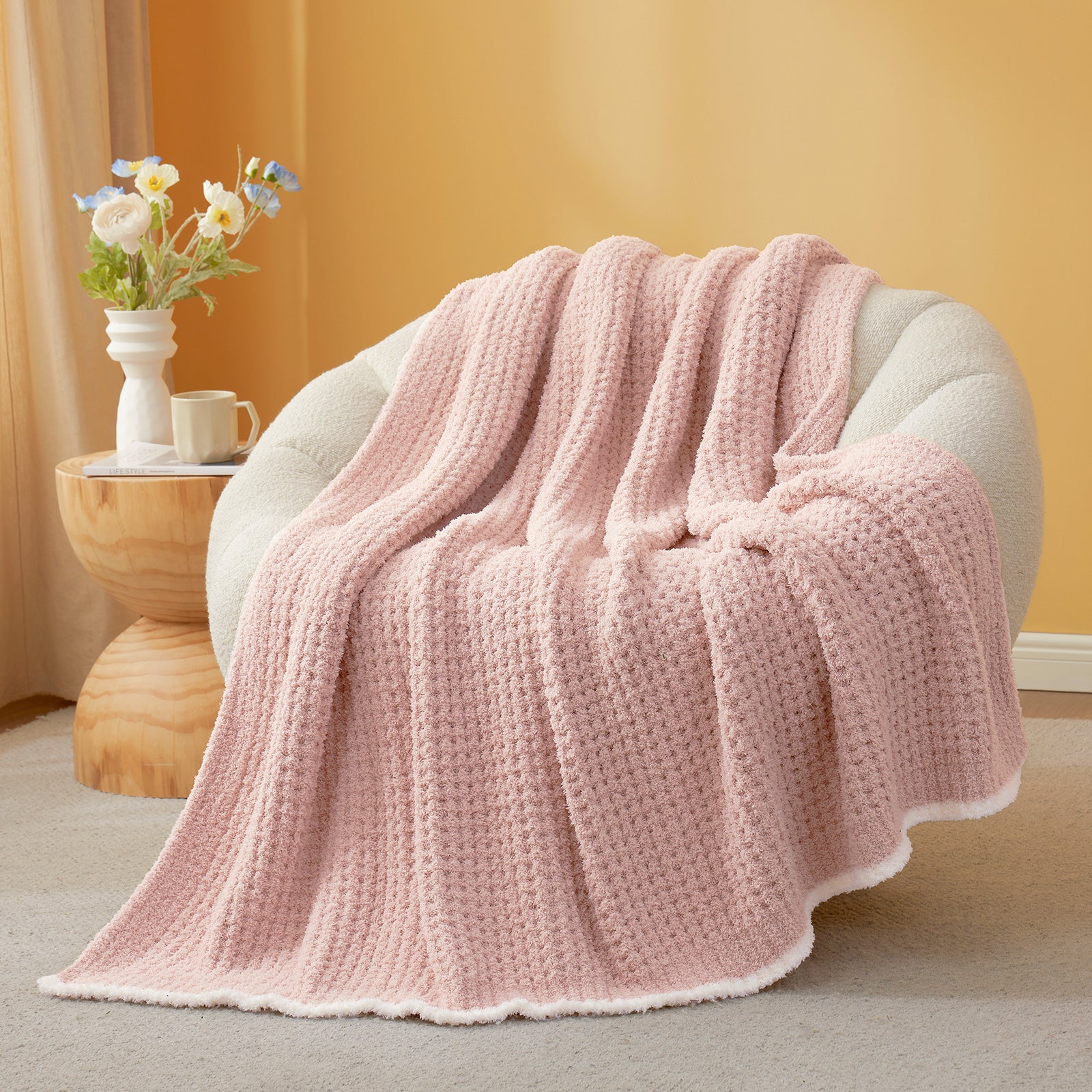 Soft Waffle Feather Yarn Knit Throw Blanket on a beige chair with vase of flower and mug#Color_Pink