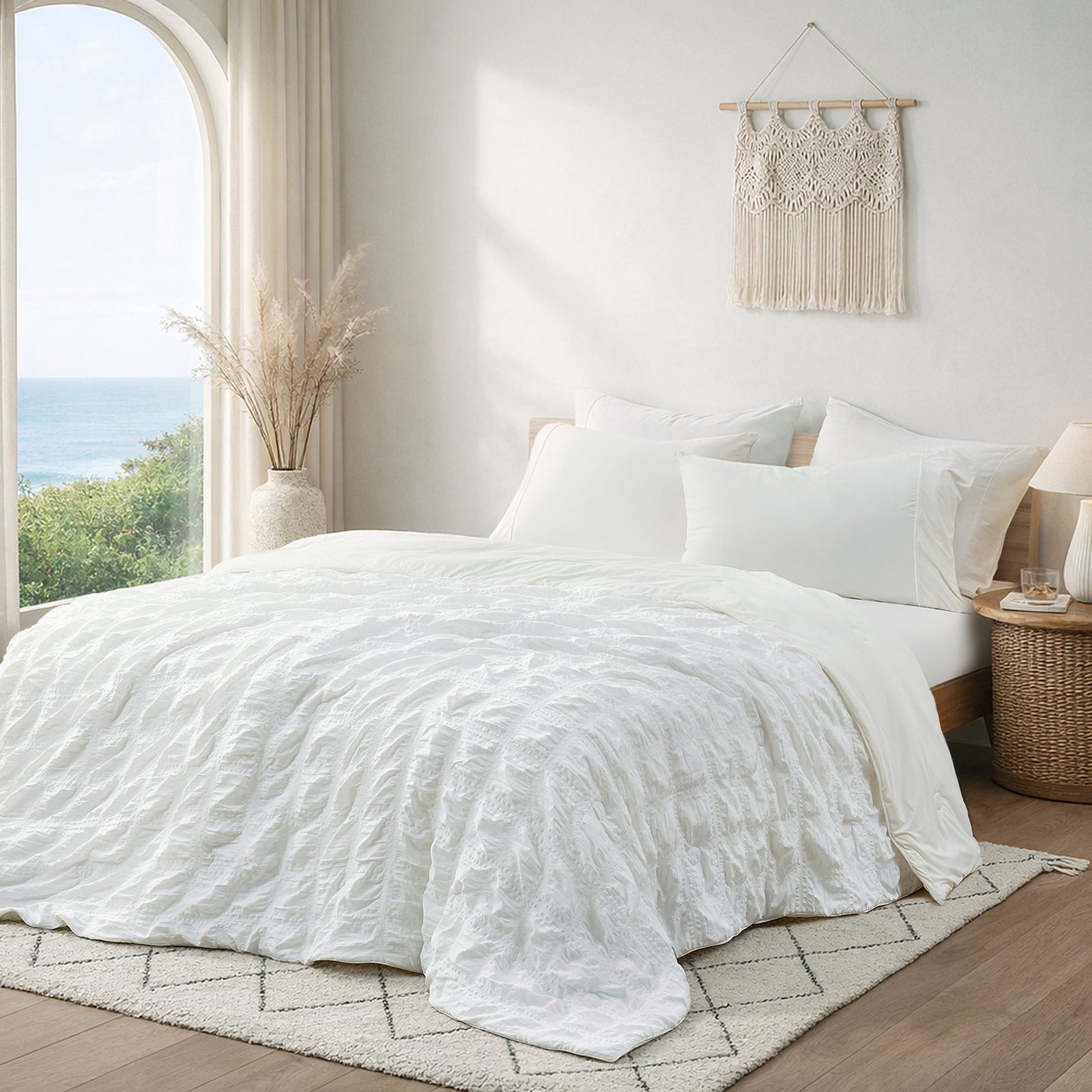 Snuggle Sac Cooling comforter in white on bed in a bedroom with window,plant and a view behind#color_White