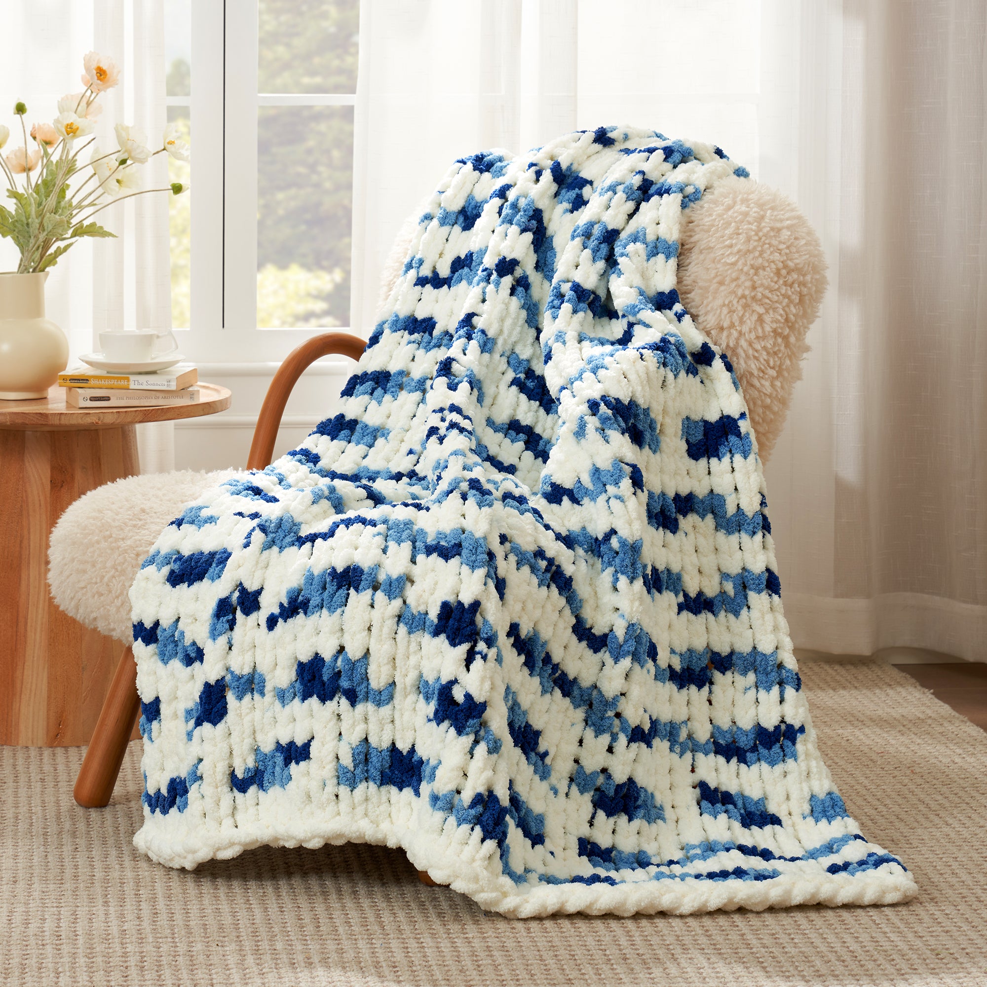 Snuggle Sac chunky chenille knit throw blanket in Blue Stripe draped over a chair creating a cozy corner #color_Blue Stripe