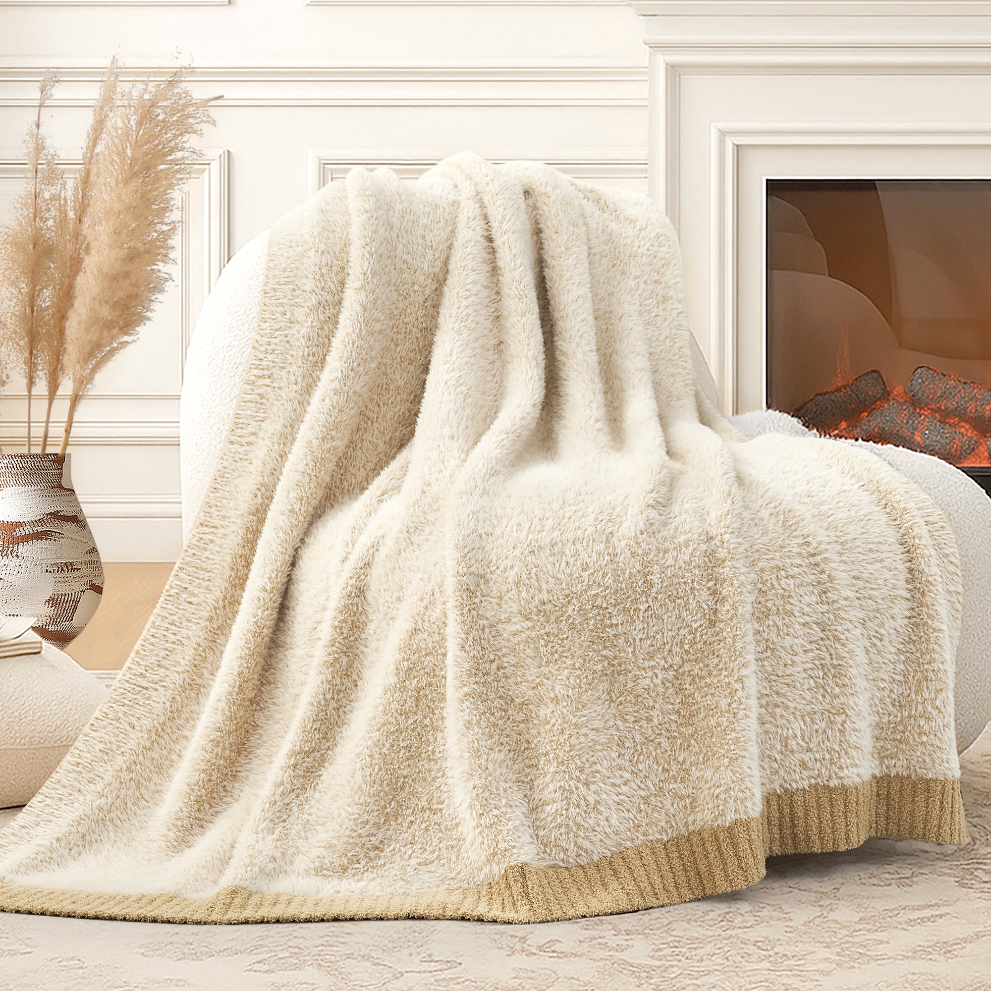 Snuggle Sac ultrasoft faux fur knit throw blanket in Beige draped over a sofa near a fireplace, creating a warm and cozy atmosphere #color_Beige