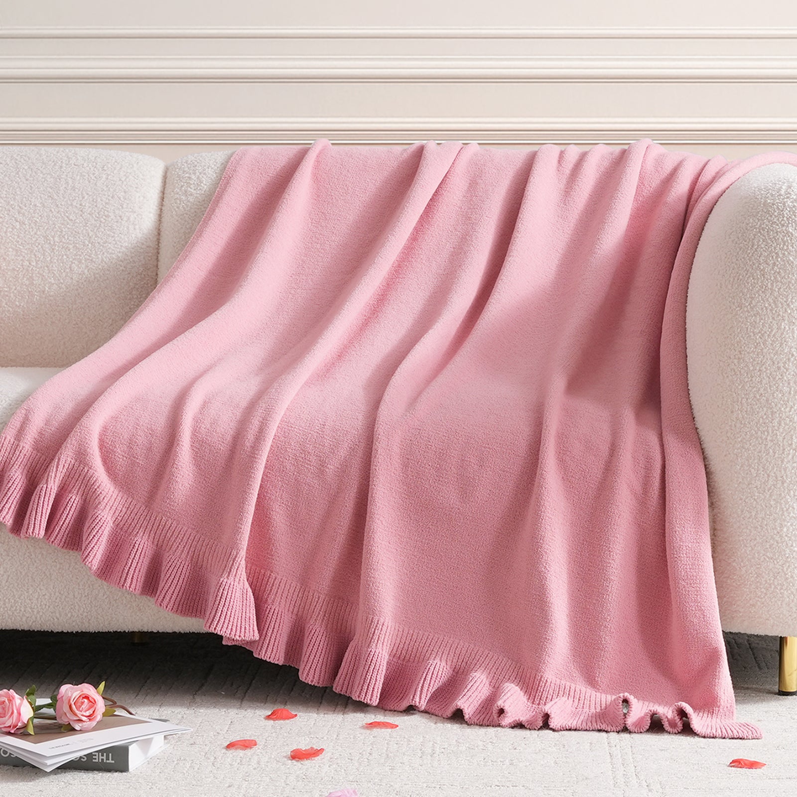Snuggle Sac chenille knit throw blanket in Pink draped over a sofa, creating a soft and cozy living space #color_Pink