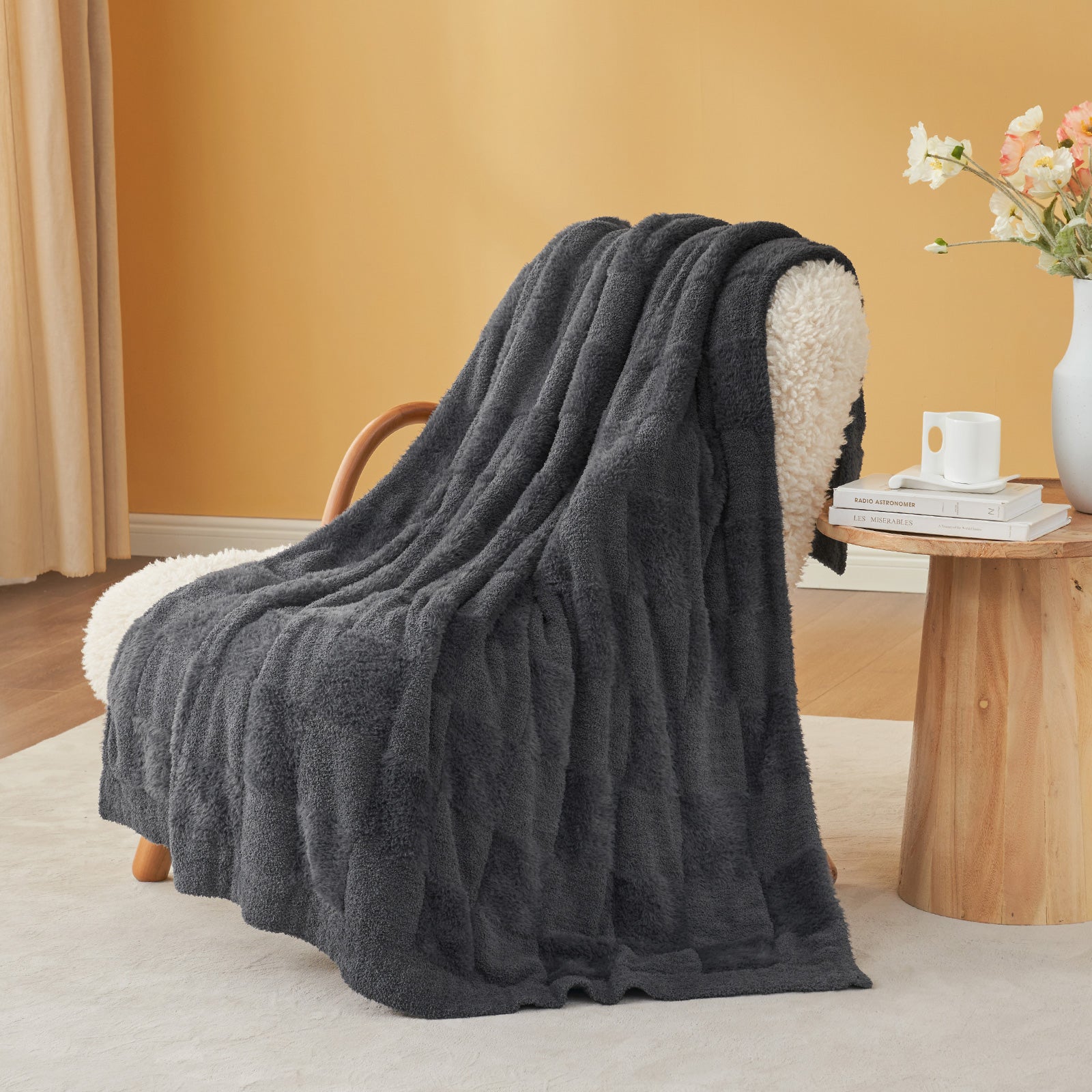 UltraCozy Solid Checkered Feather Yarn Knit Throw Blanket on a beige chair with candle and magazine- #Color_Solid Dark Grey