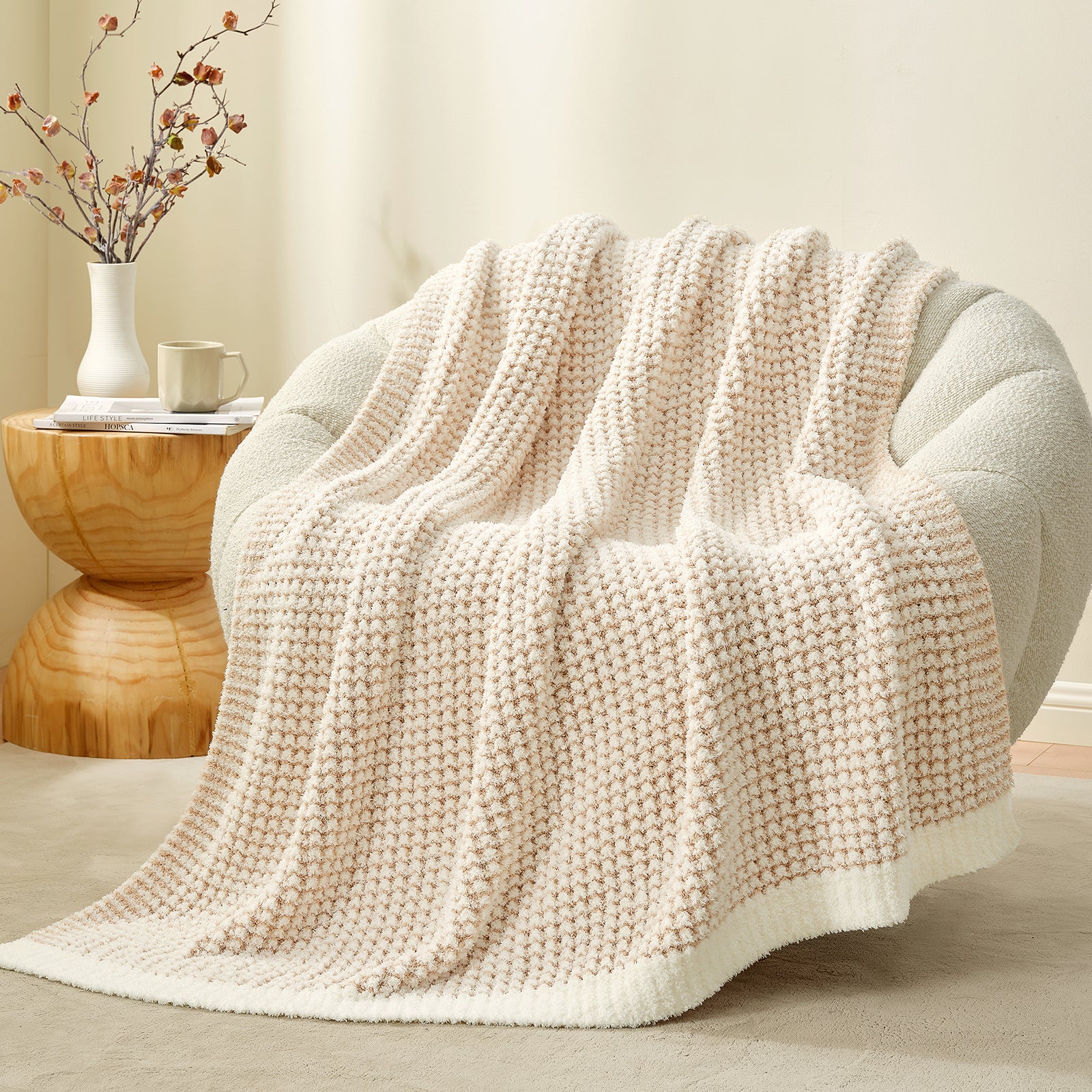 Soft Waffle Feather Yarn Knit Throw Blanket draped on a white sofa with plant and mug #color_Cream/Beige
