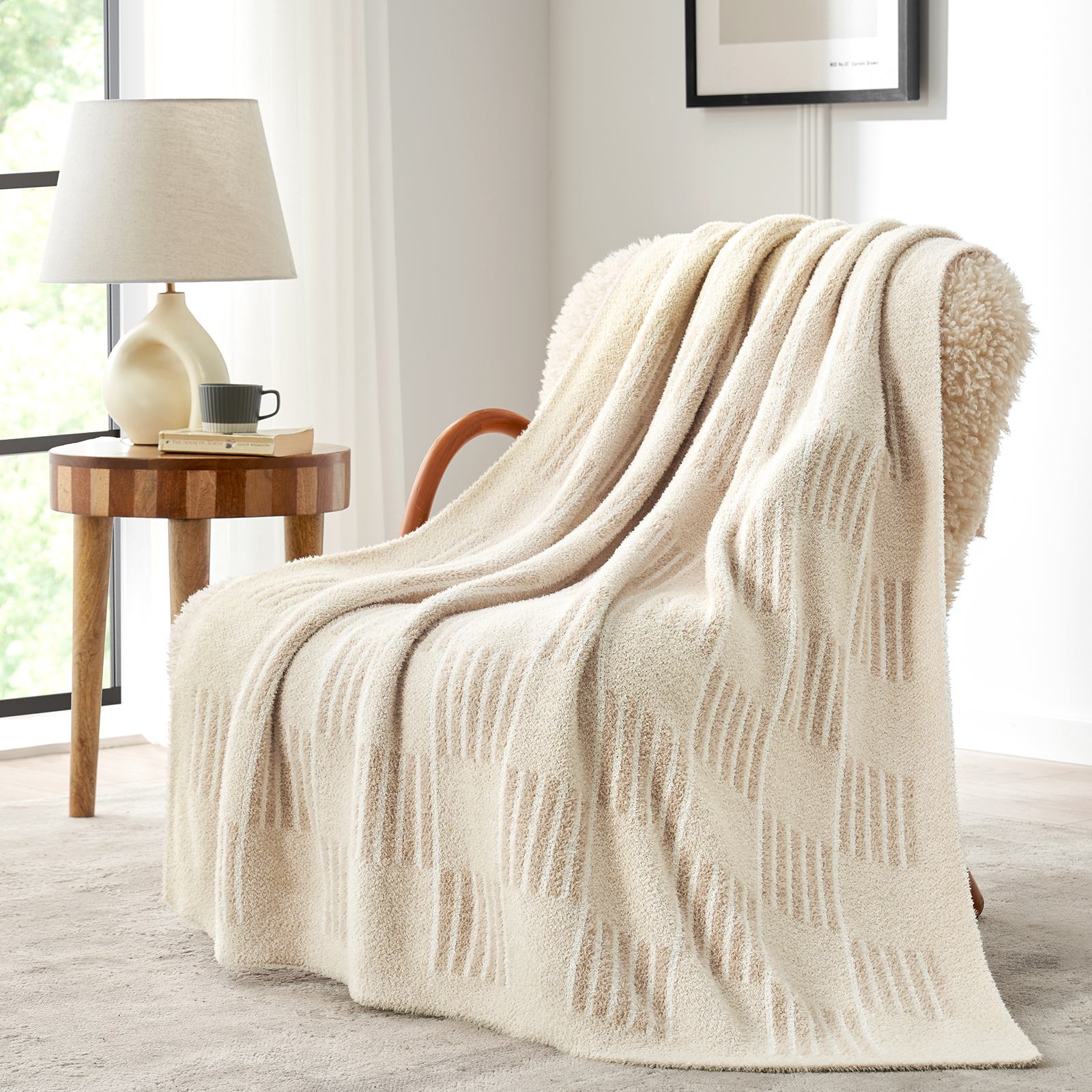 Snuggle Sacs Reversible Heather Checkered Feather Yarn Knit Throw Blanket draped on a beige chair#Color_Heather Cream