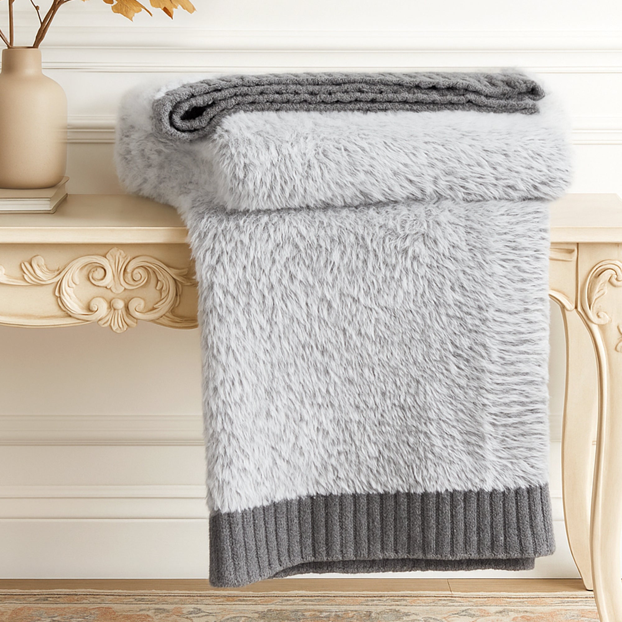 Ultrasoft faux fur knit throw blanket in Gray neatly folded on a wooden table, showcasing thick and plush texture #color_Gray