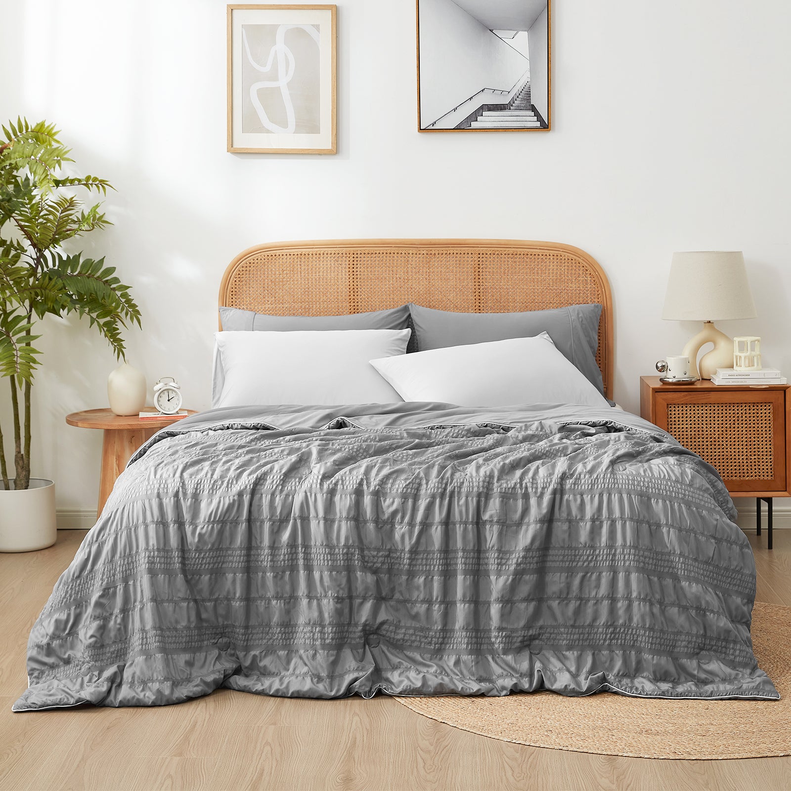 Snuggle Sac Cooling comforter in dark grey on bed in a bedroom with plants#color_Dark Grey