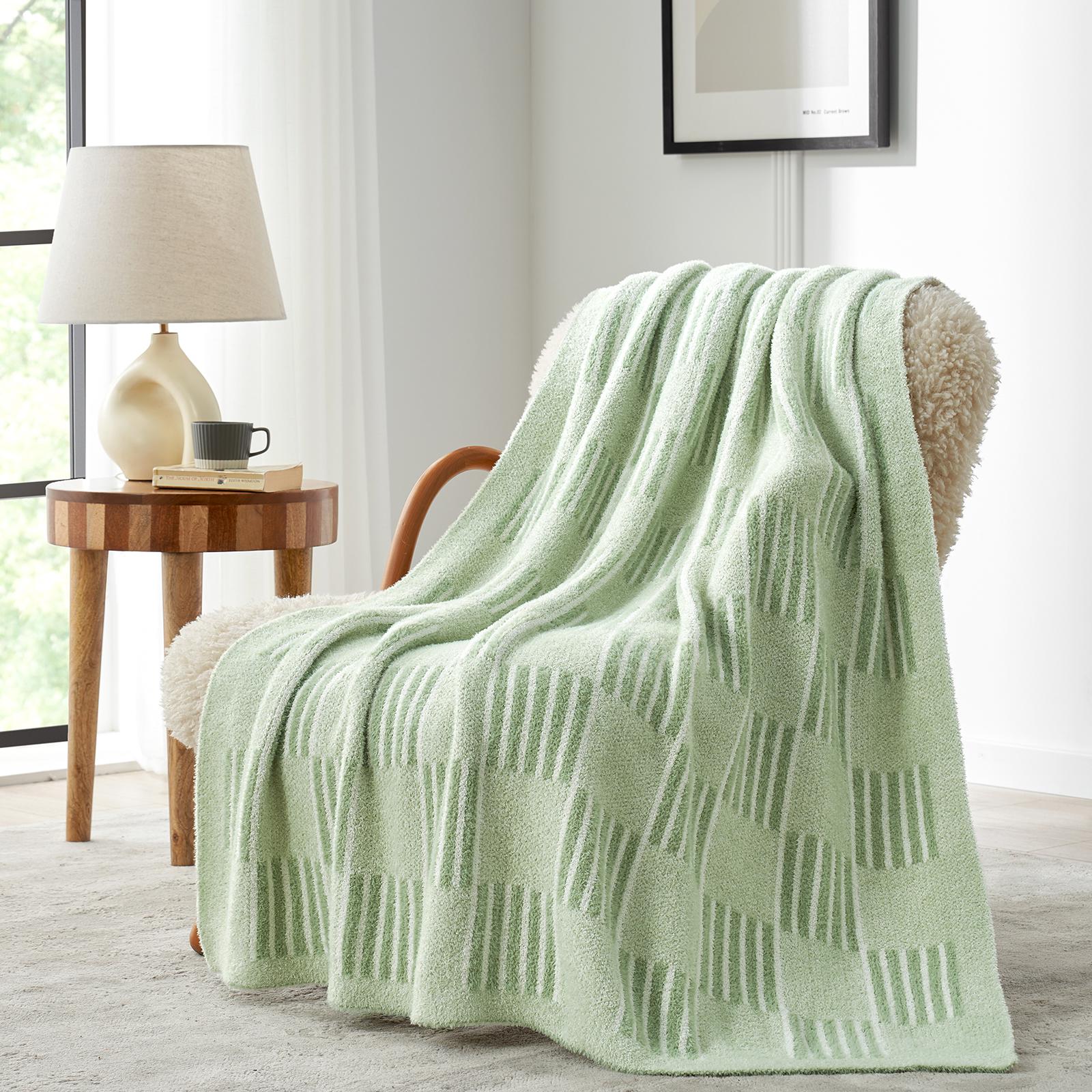 Snuggle Sacs Reversible Heather Checkered Feather Yarn Knit Throw Blanket draped on a beige chair#Color_Heather Sage Green