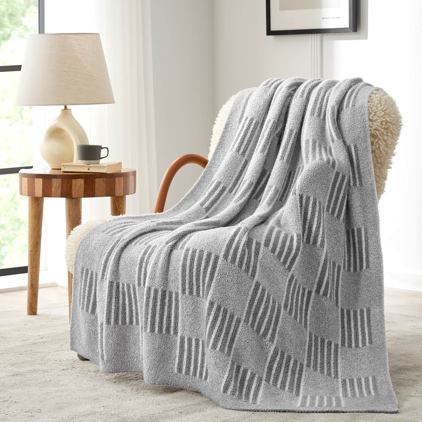 Snuggle Sacs Reversible Heather Checkered Feather Yarn Knit Throw Blanket draped on a beige chair#Color_Heather Grey