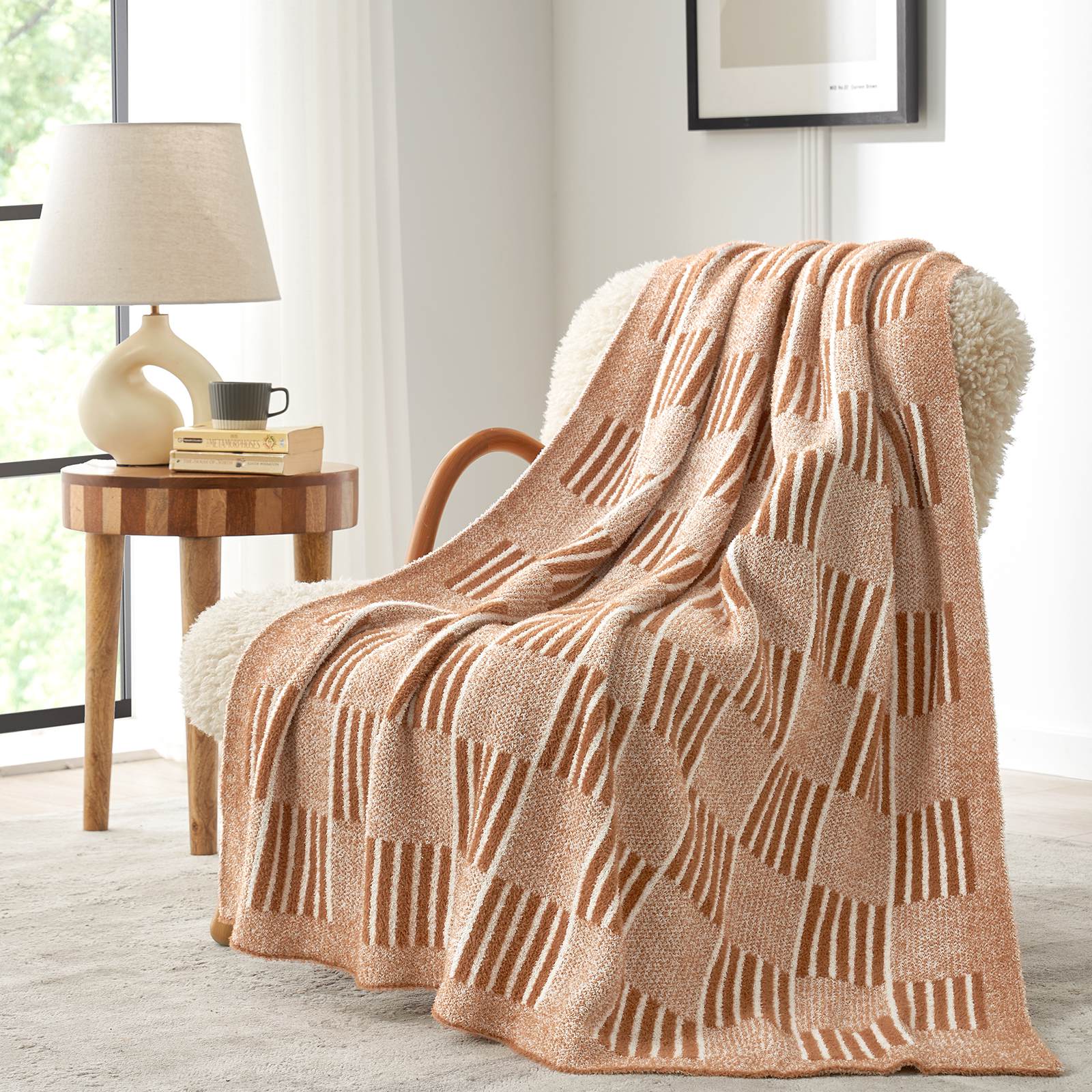 Snuggle Sacs Reversible Heather Checkered Feather Yarn Knit Throw Blanket draped on a beige chair#Color_Heather Orange