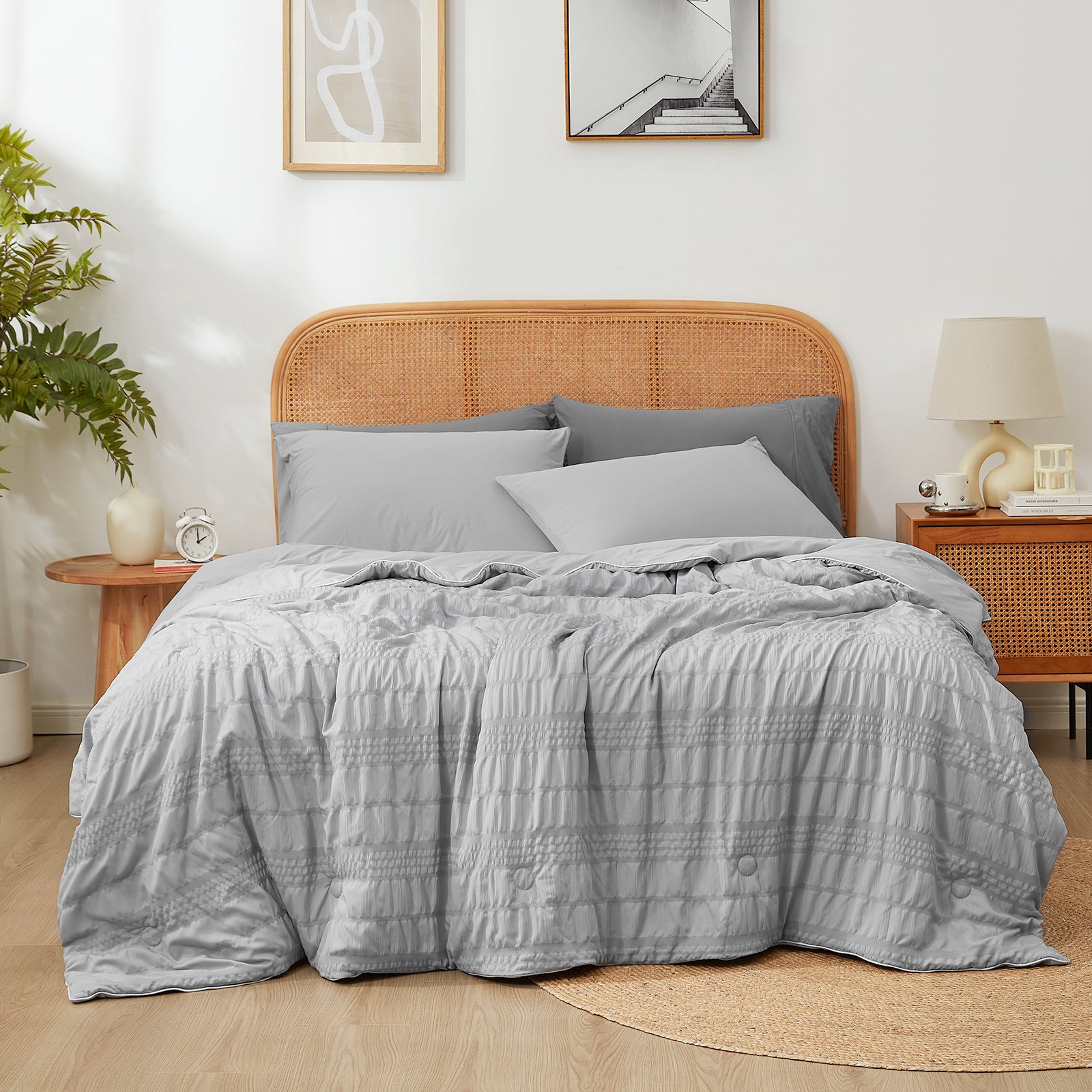 Snuggle Sac Cooling comforter in light grey on bed in a bedroom with plants#color_Light Grey