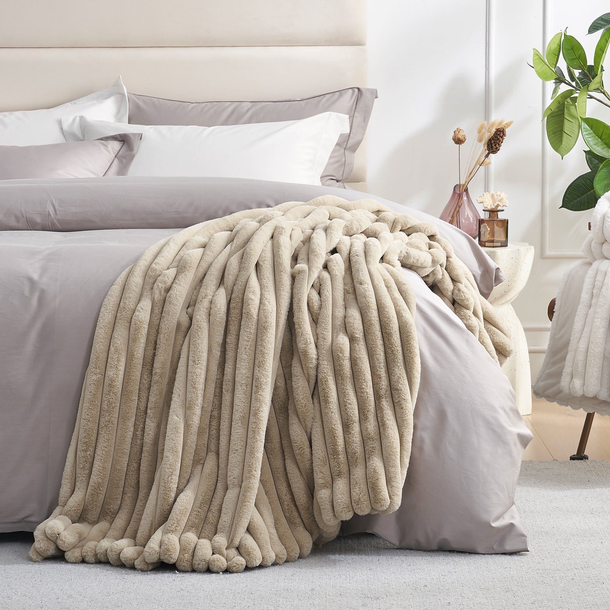 Striped faux fur throw blanket in Beige layered on a bed, creating a warm and inviting bedroom look #color_Beige
