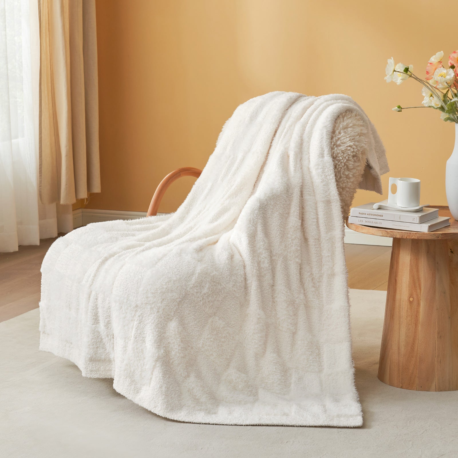 UltraCozy Solid Checkered Feather Yarn Knit Throw Blanket on a beige chair with candle and magazine - #Color_Solid Ivory