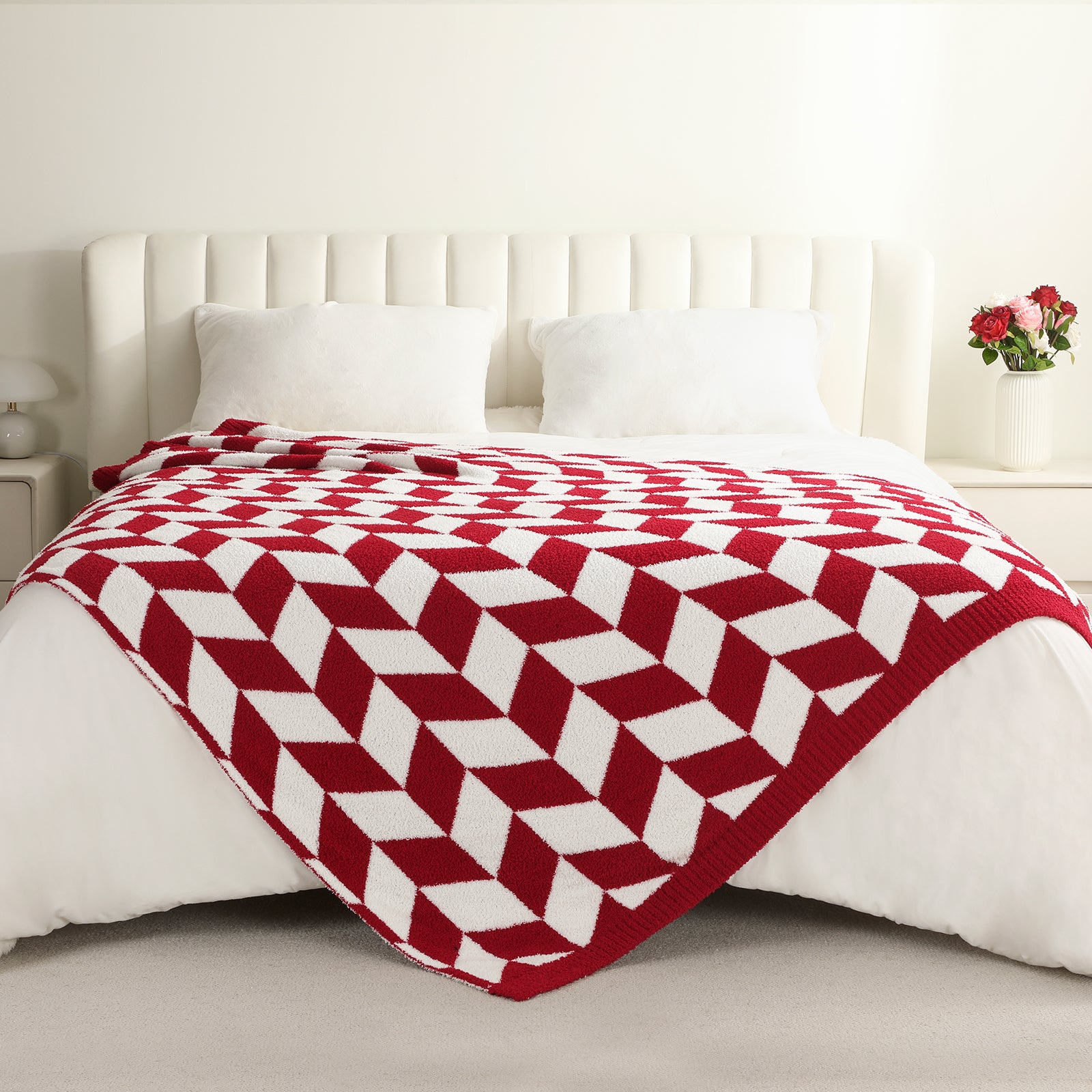 Red and white patterned blanket on a bed in a bedroom setting #color_Red/Cream