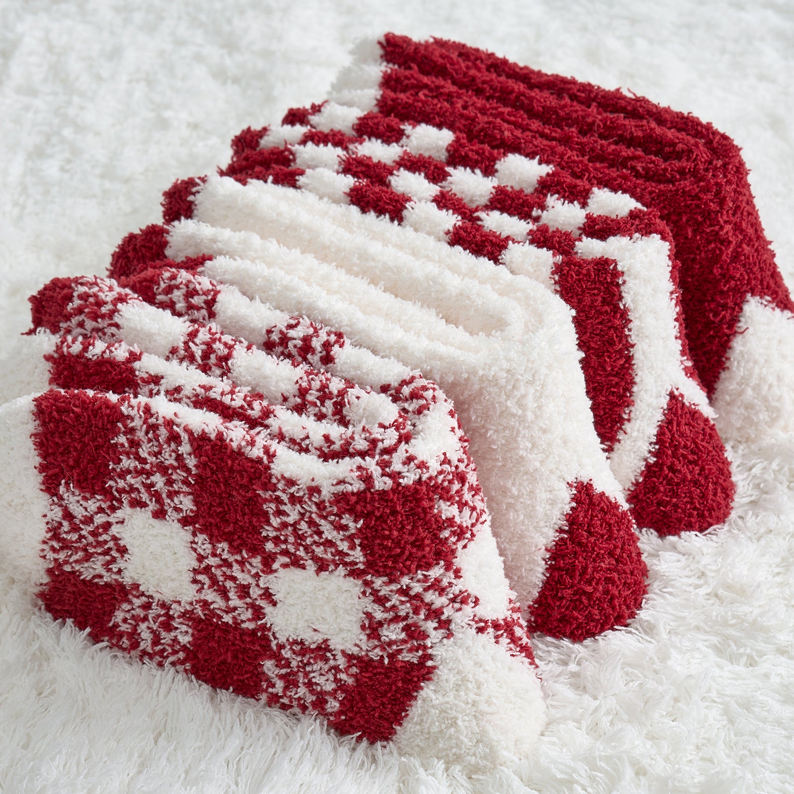 Women checkered and striped socks 4 pairs in Red folded together, showcasing soft fuzzy texture and winter patterns #color_Red