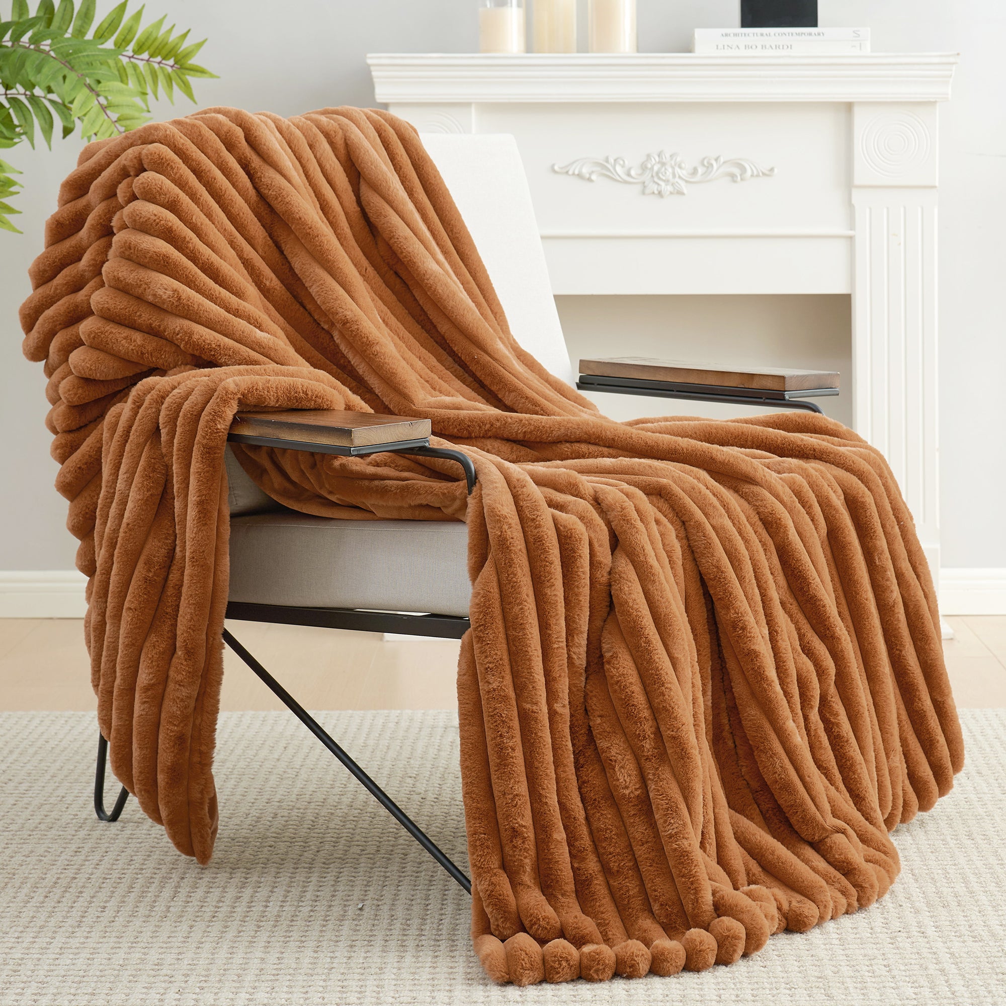 Snuggle Sac striped faux fur throw blanket in Burnt Orange draped over a chair, creating a warm and inviting atmosphere #color_Burnt Orange