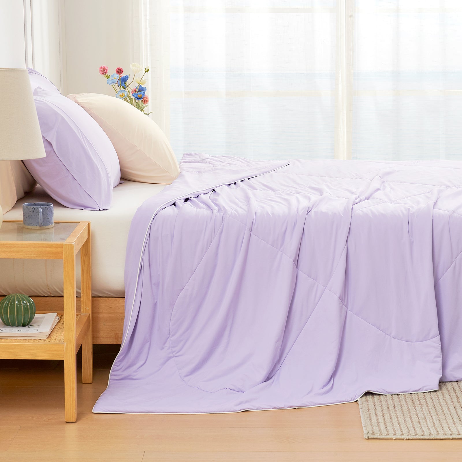 Left side view of bed with a purple Snuggle Sac comforter in a bright bedroom#color_Purple
