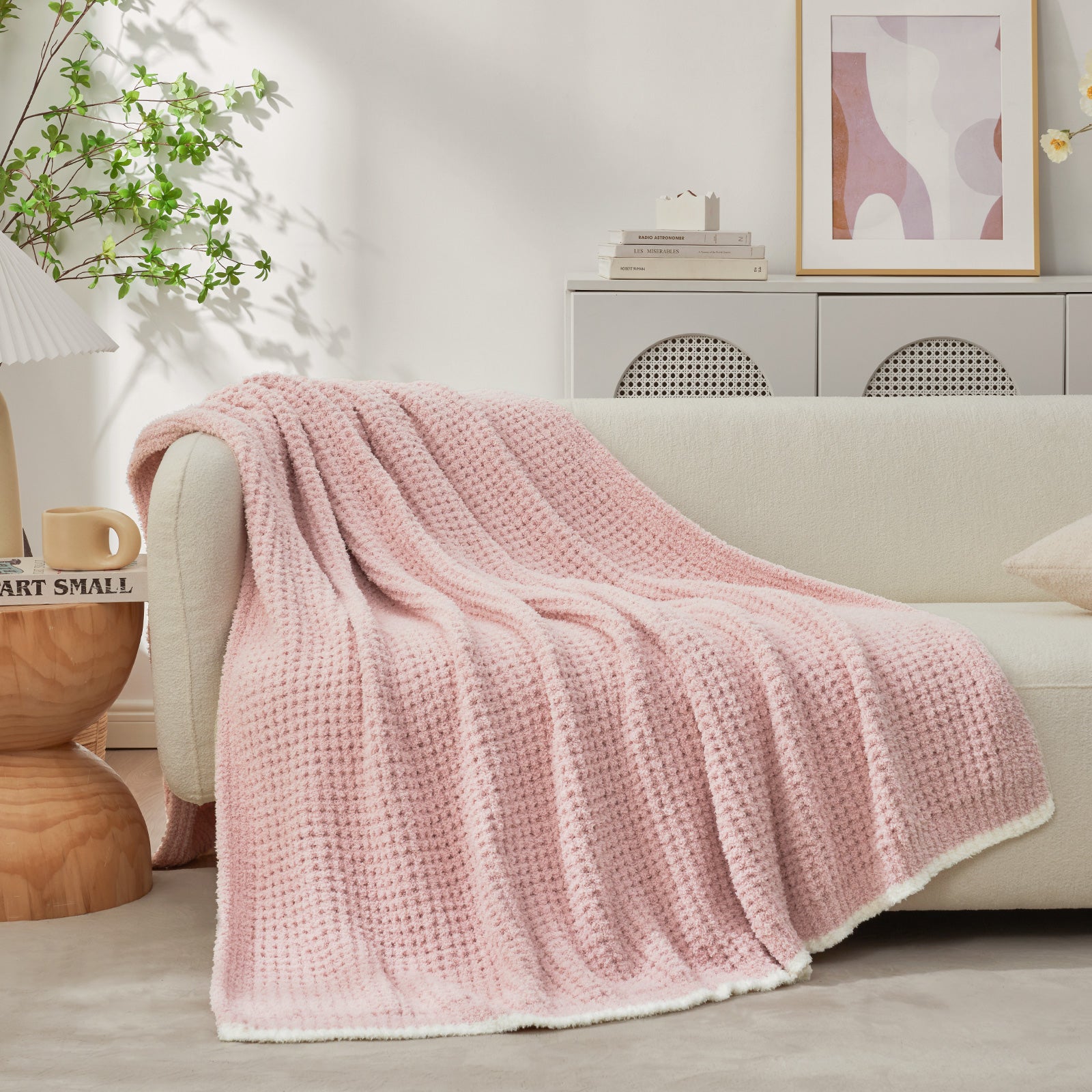 Soft Waffle Feather Yarn Knit Throw Blanket on a beige couch with vase of plant and mug#Color_Pink