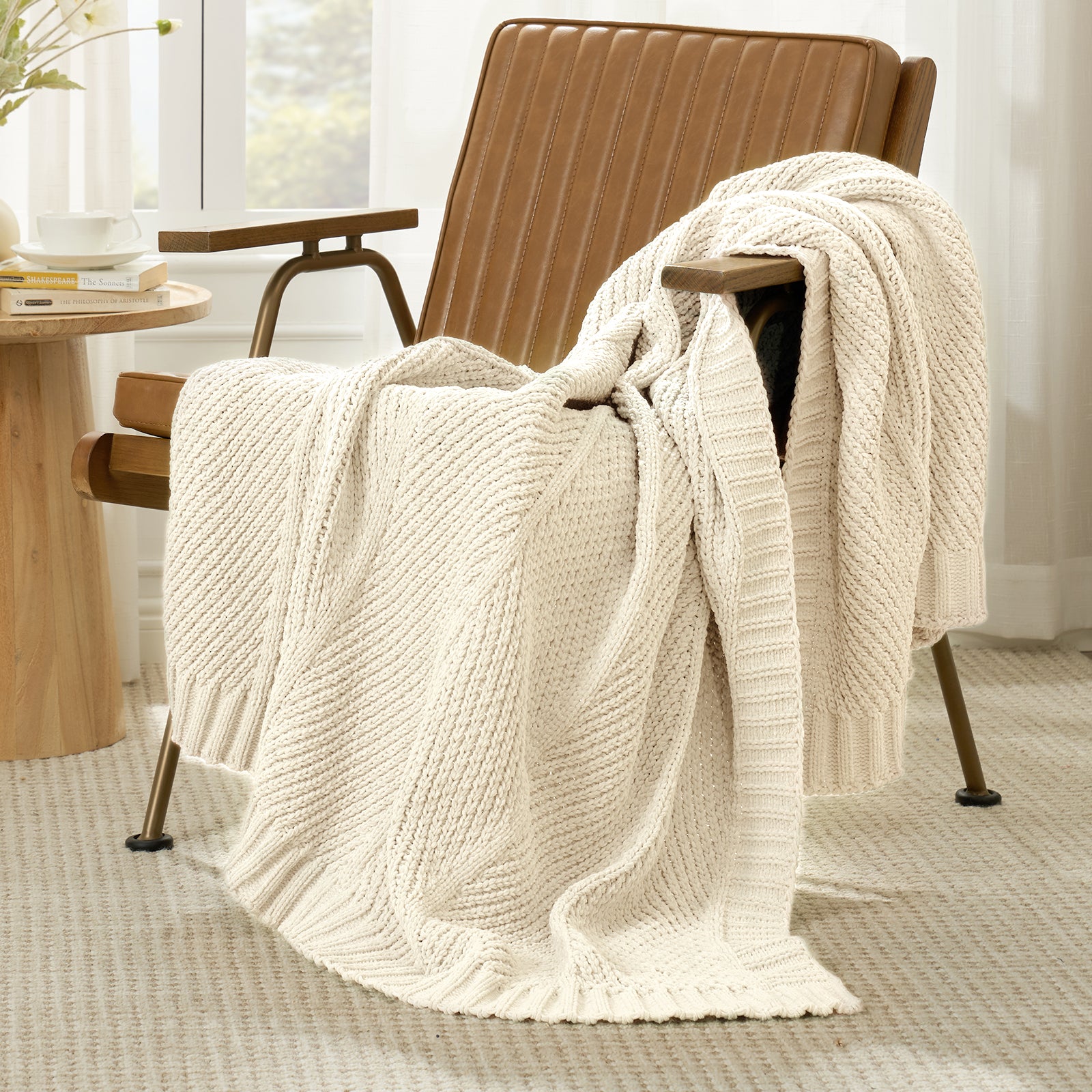 Snuggle Sac chevron chenille knit throw blanket in Ivory casually draped over a chair in a cozy setting #color_Ivory