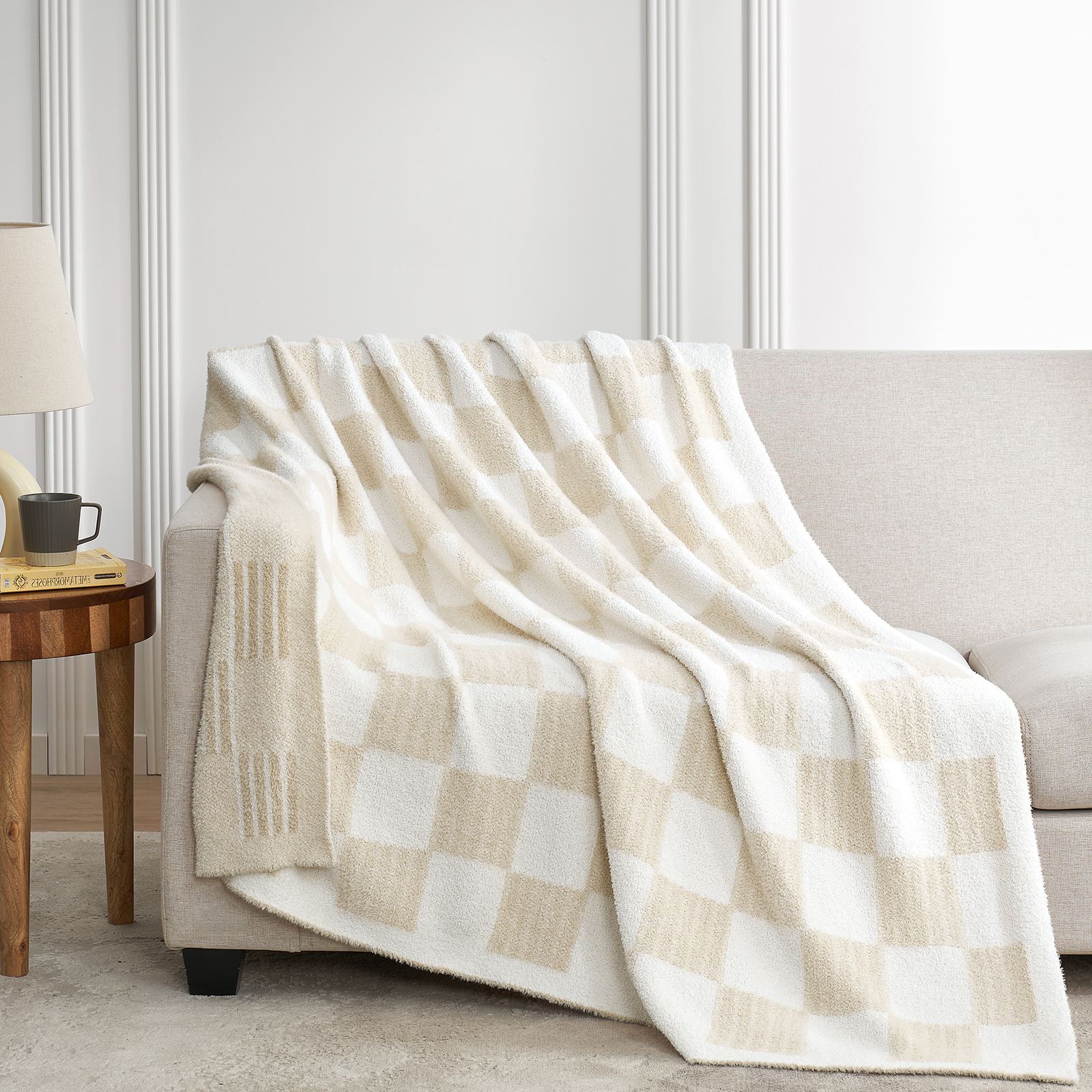 Snuggle Sacs Reversible Heather Checkered Feather Yarn Knit Throw Blanket draped on a grey couch#Color_Heather Cream