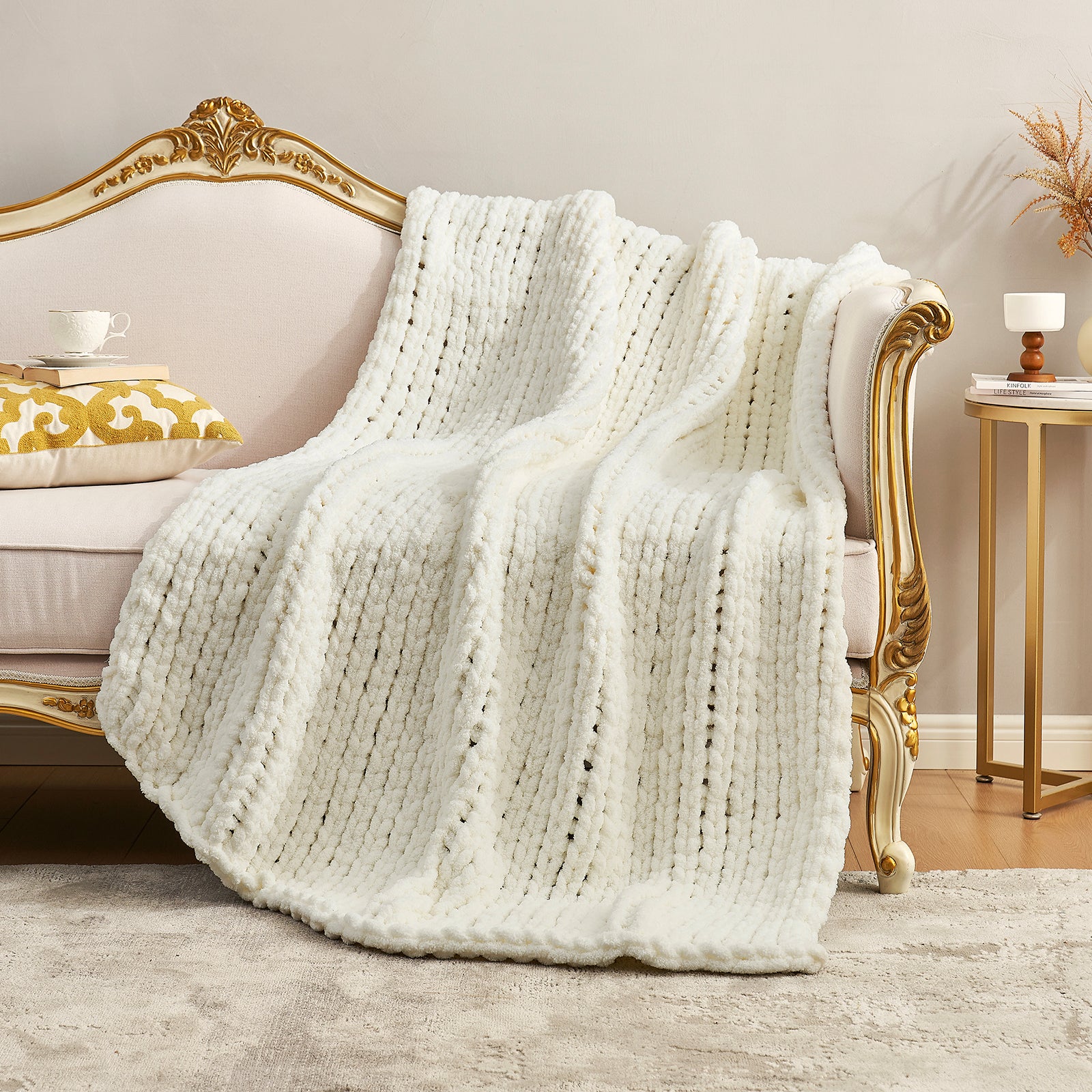 Textured chunky knit throw blanket in Ivory elegantly spread over a sofa #color_Ivory