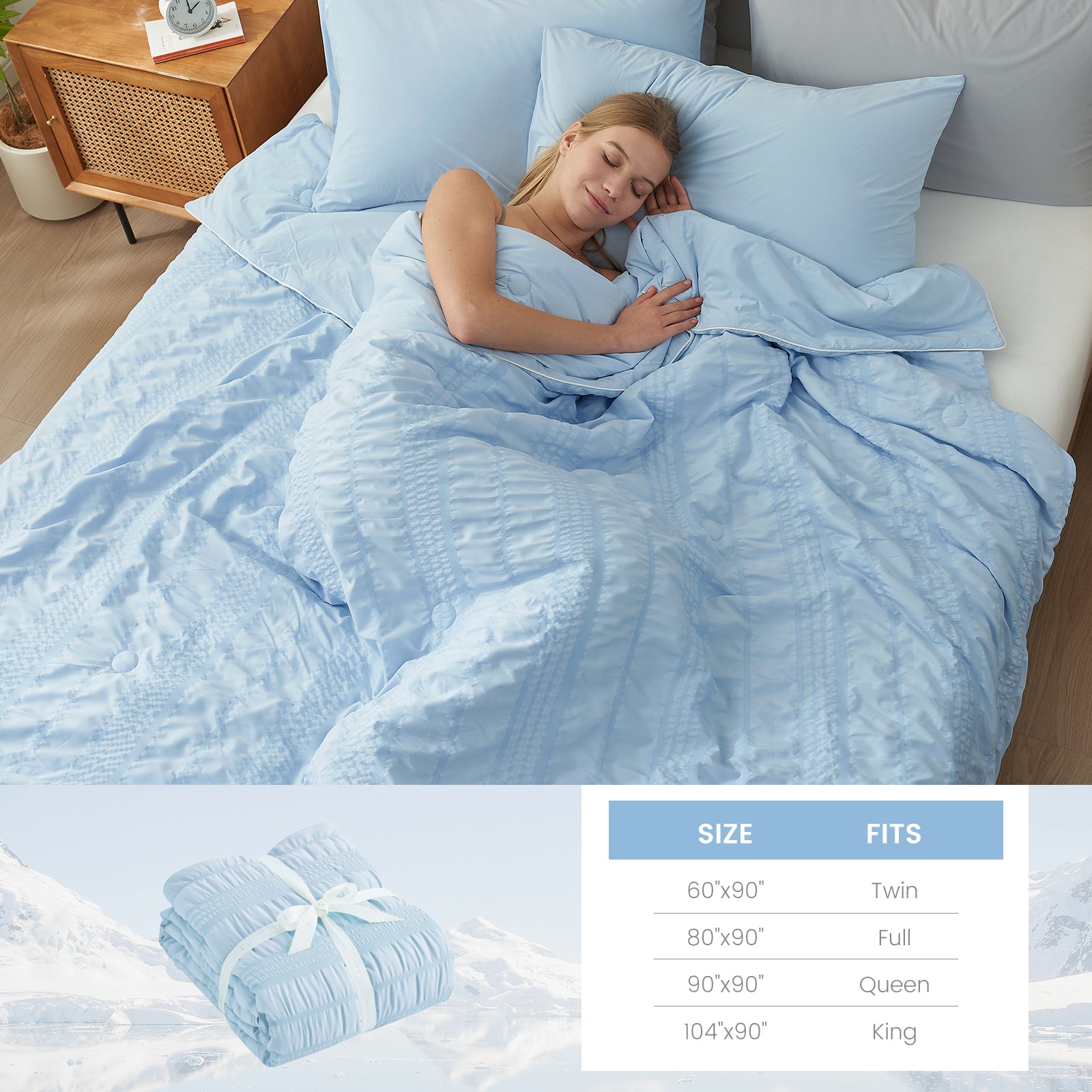 A woman laying down on the bed with Snuggle Sac Cooling comforter #color_Blue