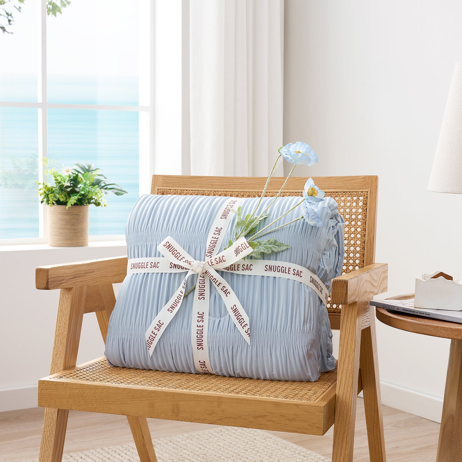Folded Snuggle Sac blue comforter with white ribbon,perfect as gift.#color_Blue