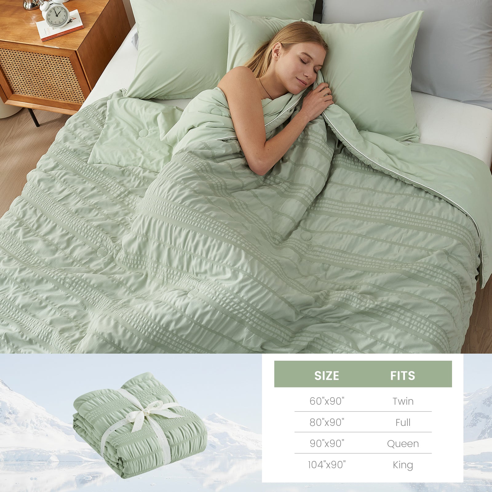 A woman laying down on the bed with Snuggle Sac Cooling comforter #color_Sage Green