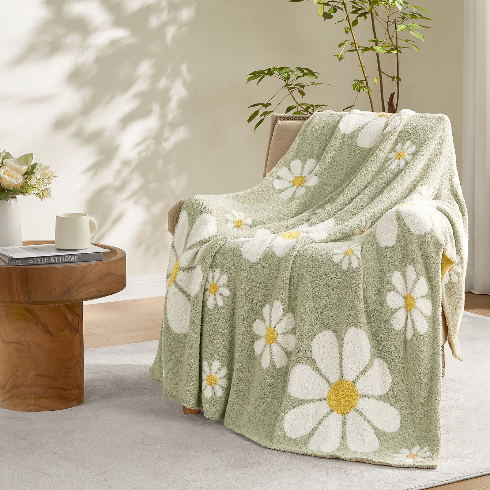 Snuggle Sacs Spring Floral Feather Yarn Knit Throw Blanket draped over a broen chair#Color_Sage Green
