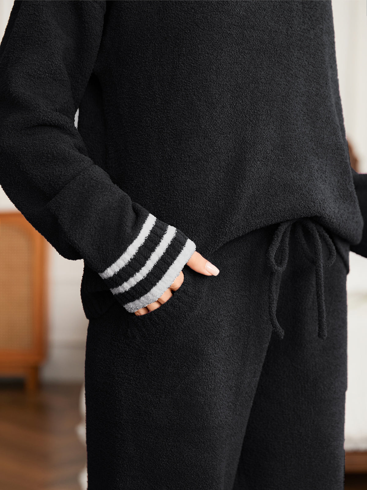 Close up of women long sleeve crewneck knit loungewear set in Black, showcasing drawstring waist and soft knit texture #color_Black