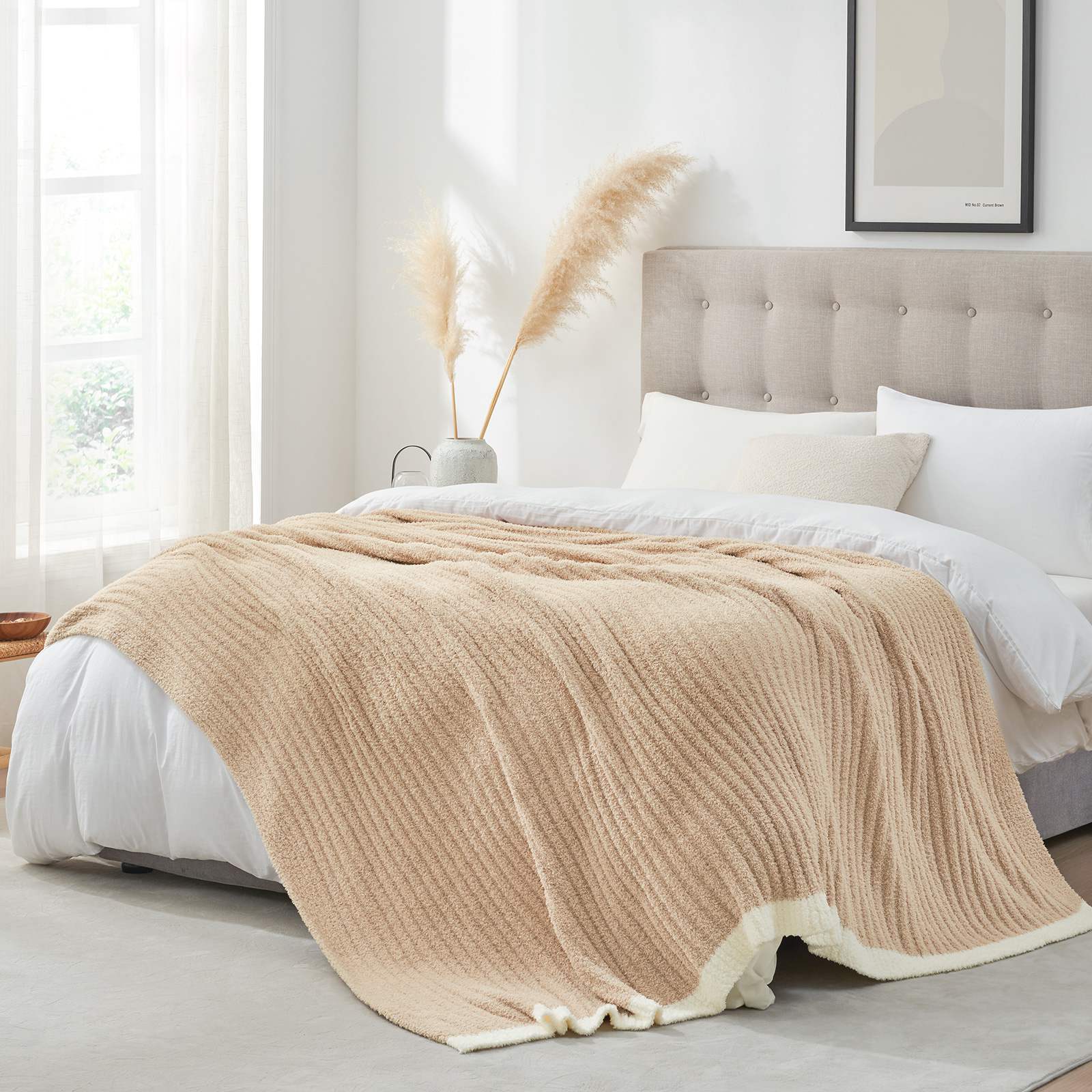 Snuggle Sac UltraSoft Ribbed Feather Yarn Knit Throw Blanket on the bed with a window and decorations#Color_Beige