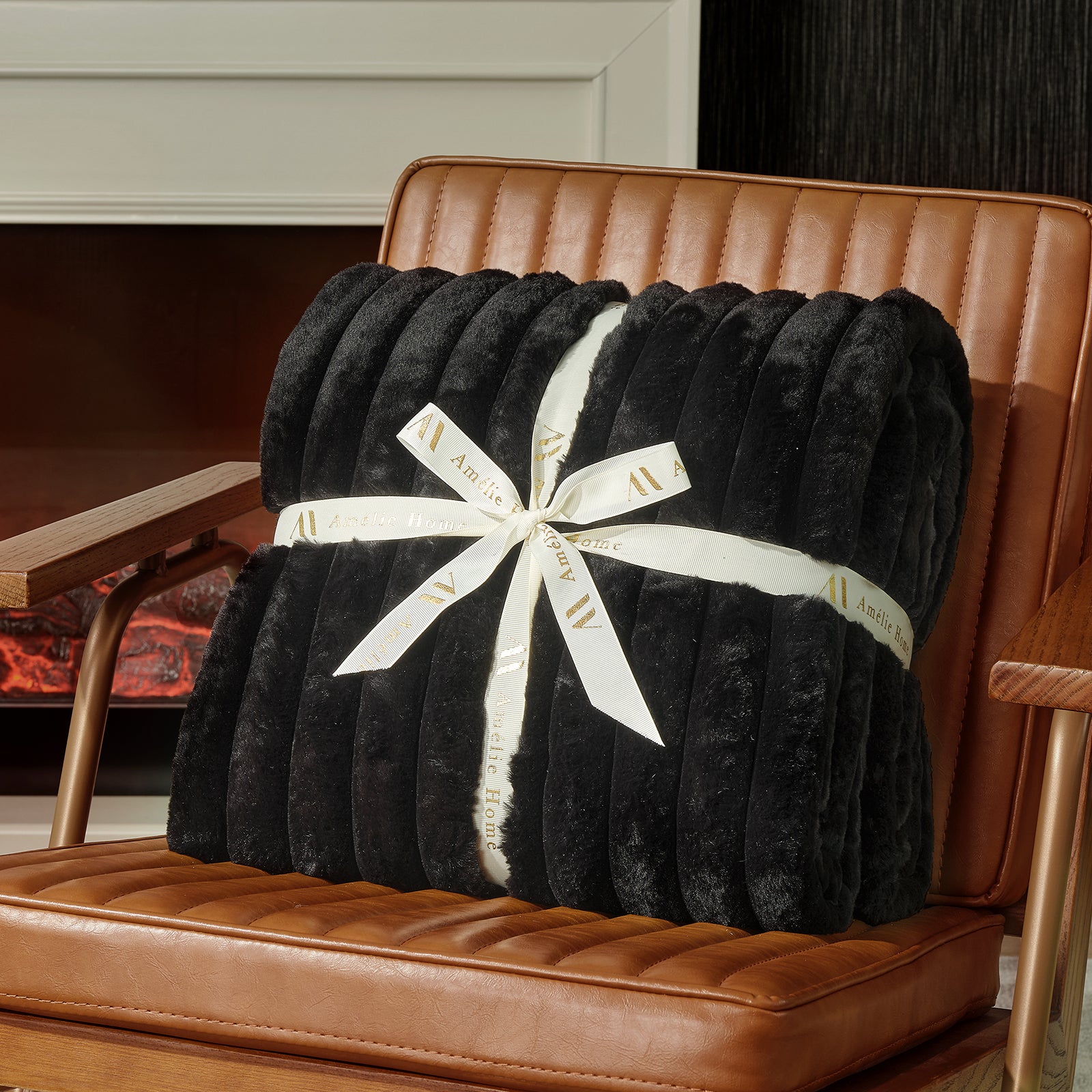 Striped faux fur throw blanket in Black folded with ribbon, perfect for gifting #color_Black