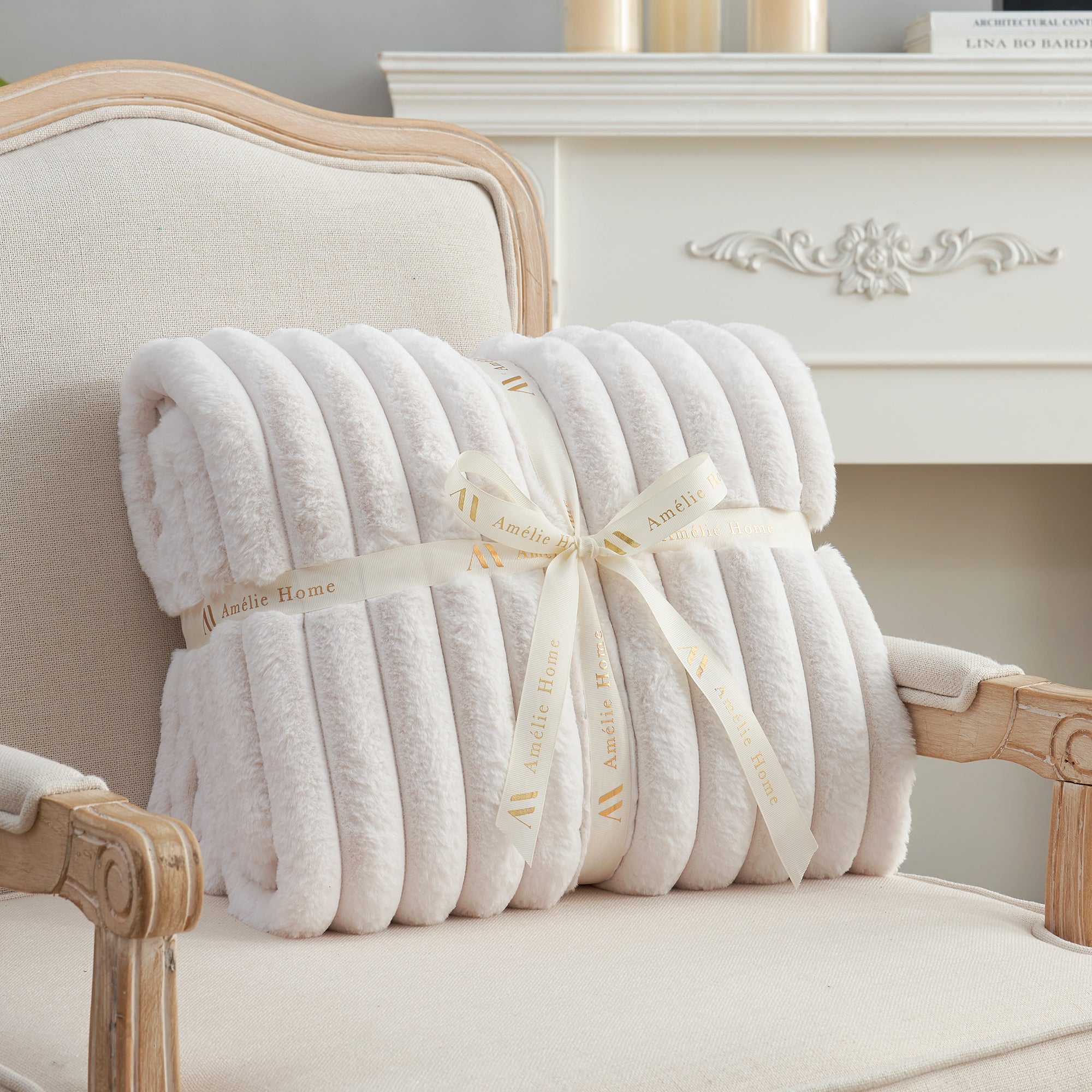 Striped faux fur throw blanket in Ivory folded with ribbon, perfect for gifting #color_Ivory