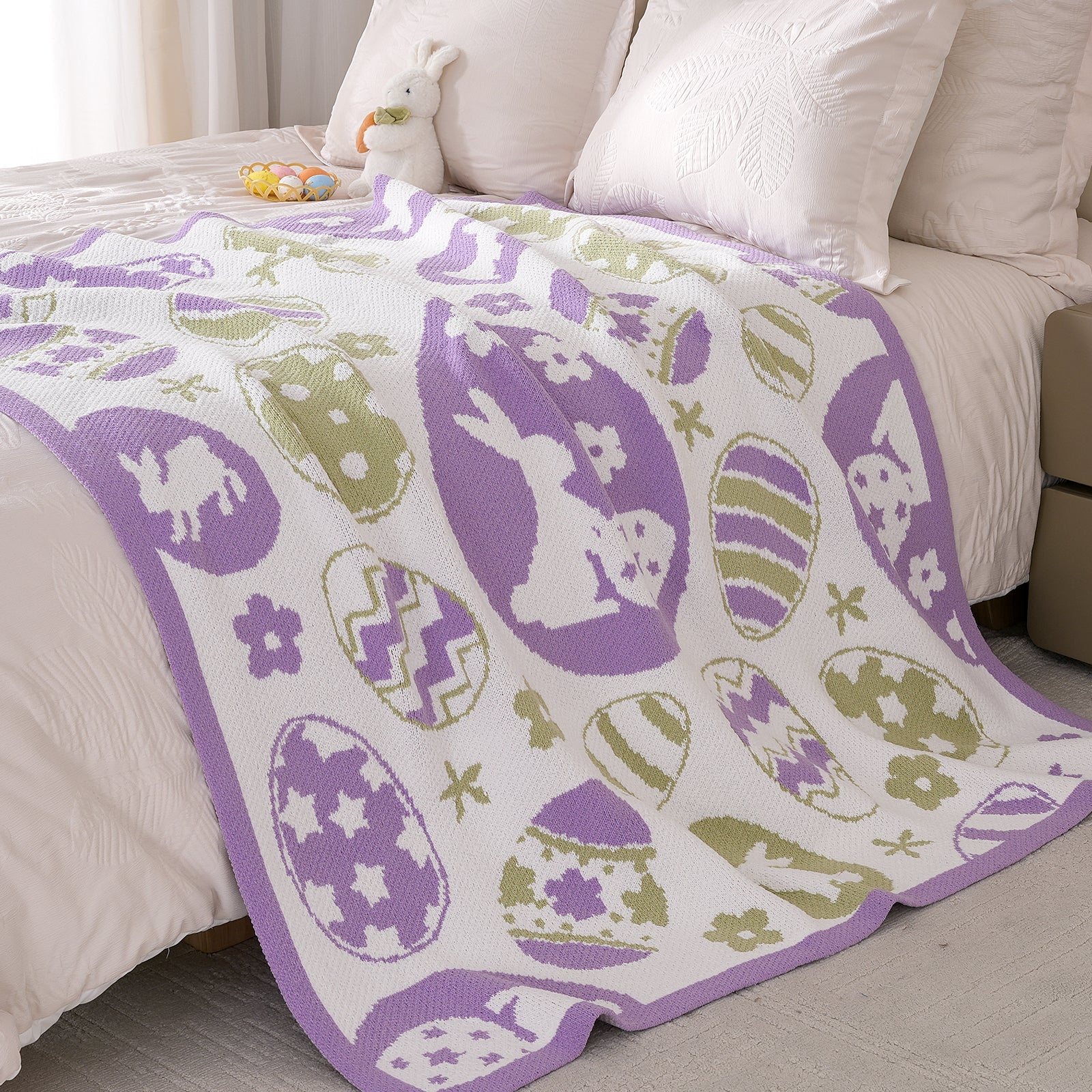 Snuggle Sac easter bunny and eggs chenille knit throw blanket spread across a bed #color_Purple