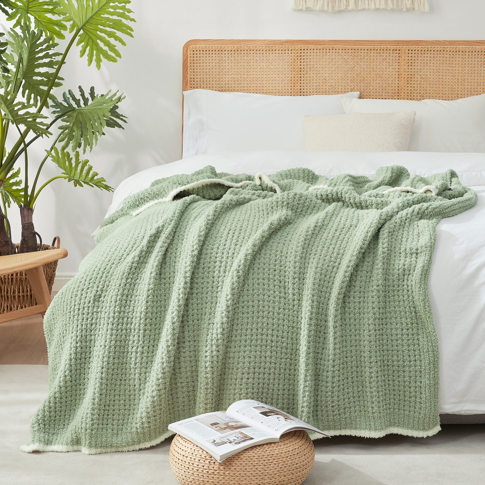 Soft Waffle Feather Yarn Knit Throw Blanket on the bed with vase of plants and magazine#Color_Sage Green