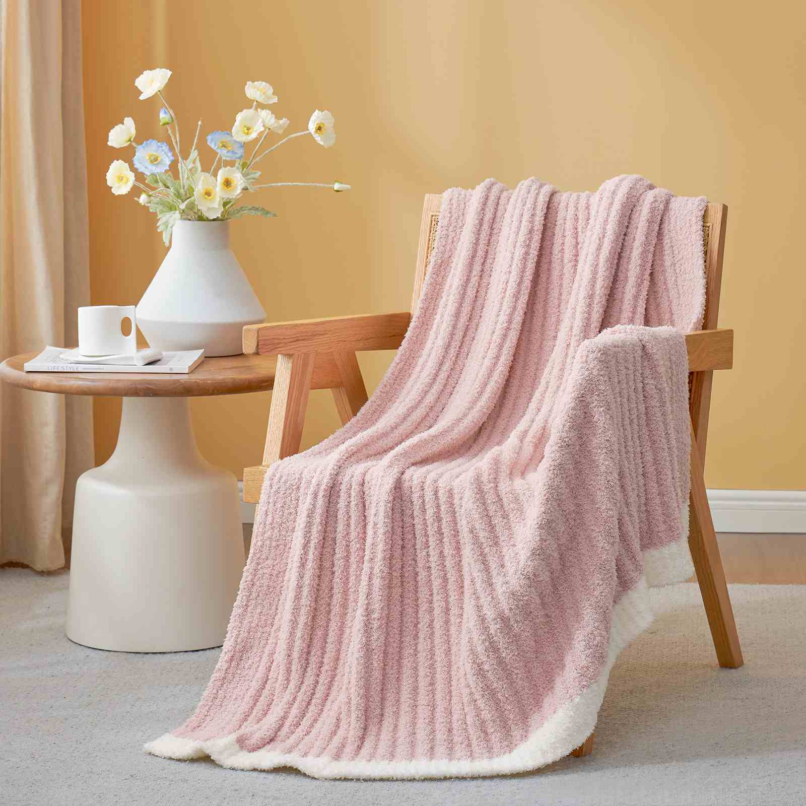 Snuggle Sac UltraSoft Ribbed Feather Yarn Knit Throw Blanket draped on the chair with a vase of flower#Color_Pink
