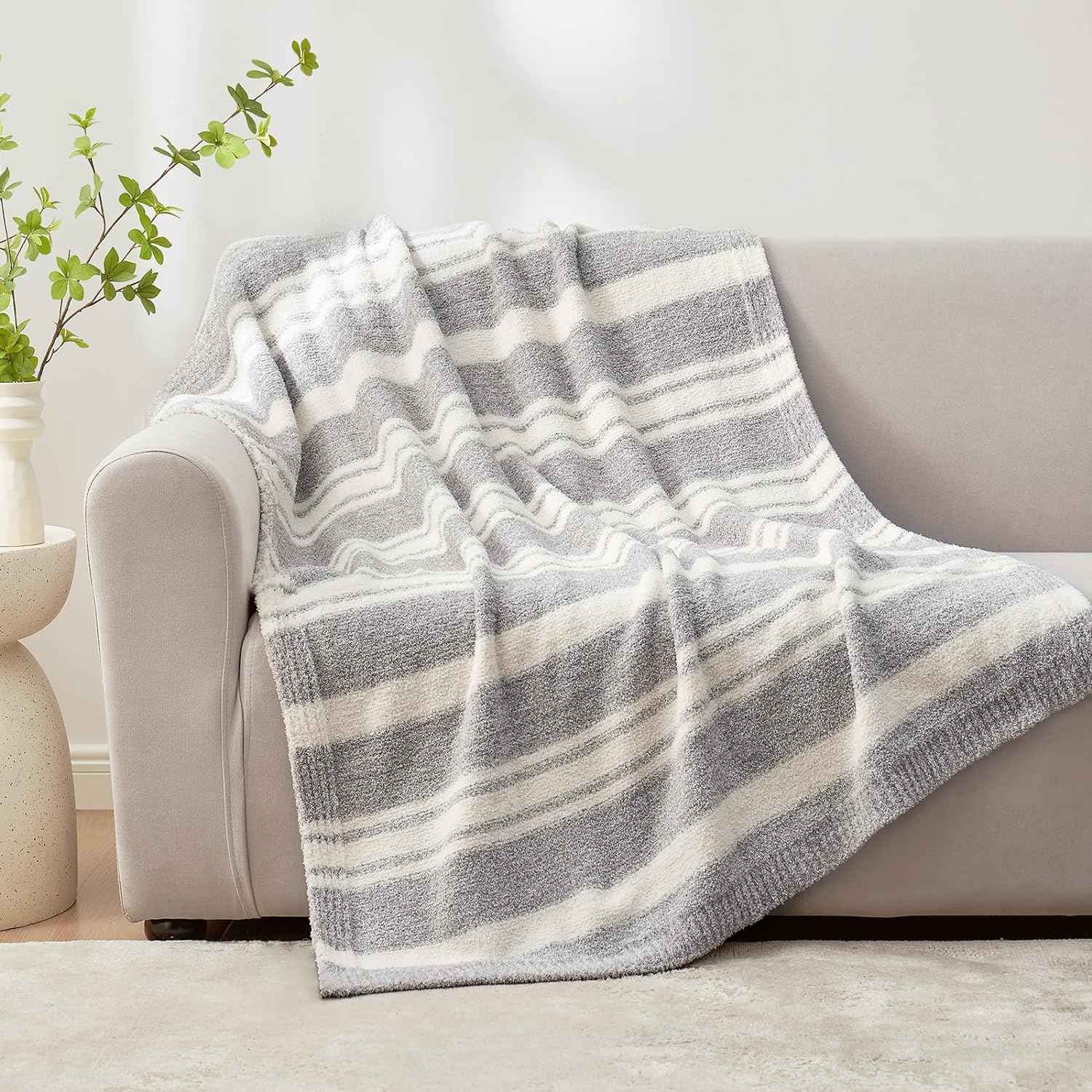 Striped Feather Yarn Knit Throw Blanket on a grey couch#Color_Grey