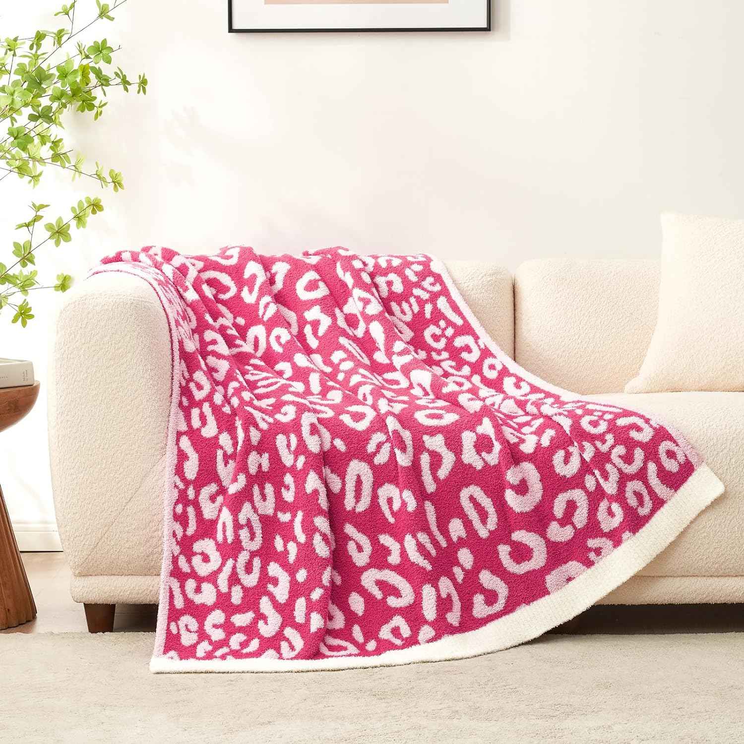 Reversible Leopard Feather Yarn Knit Throw Blanket on a beige couch in a bright room#Color_Hot Pink