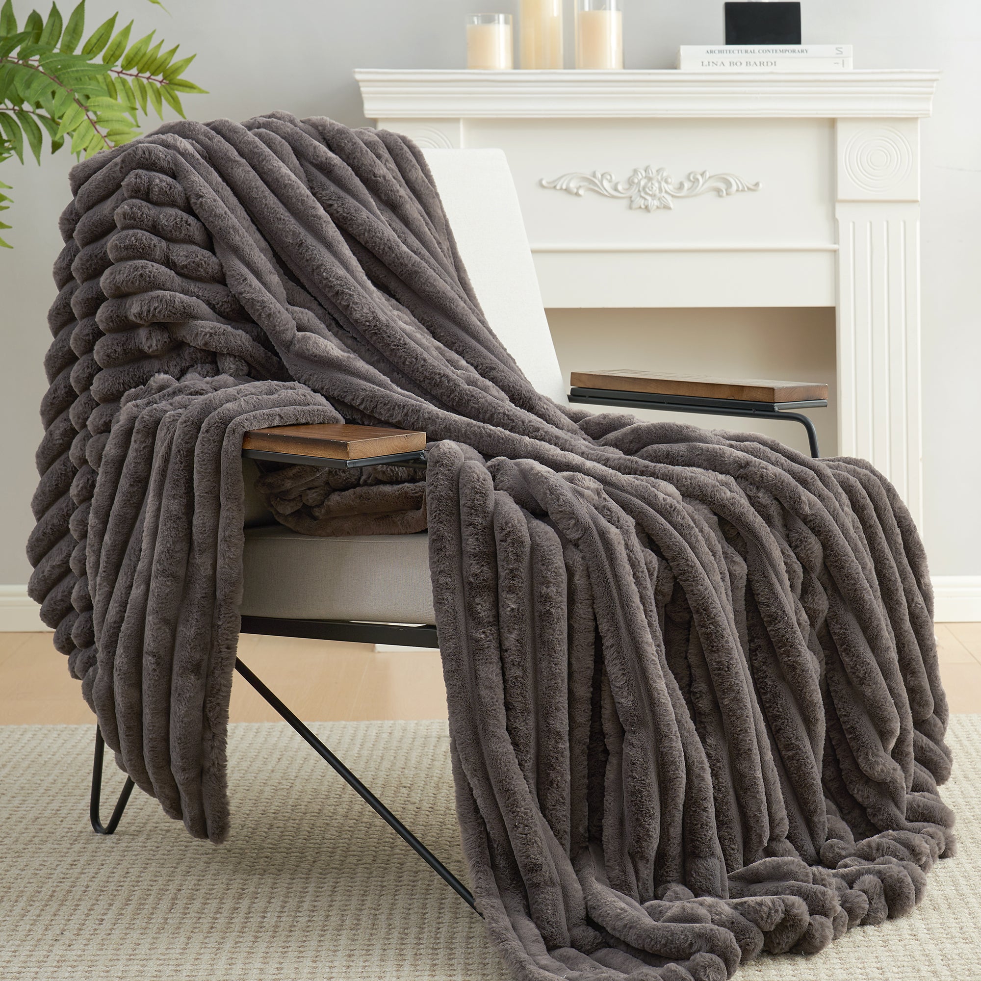 Snuggle Sac striped faux fur throw blanket in Charcoal Grey draped over a chair, creating a warm and inviting atmosphere #color_Charcoal Grey