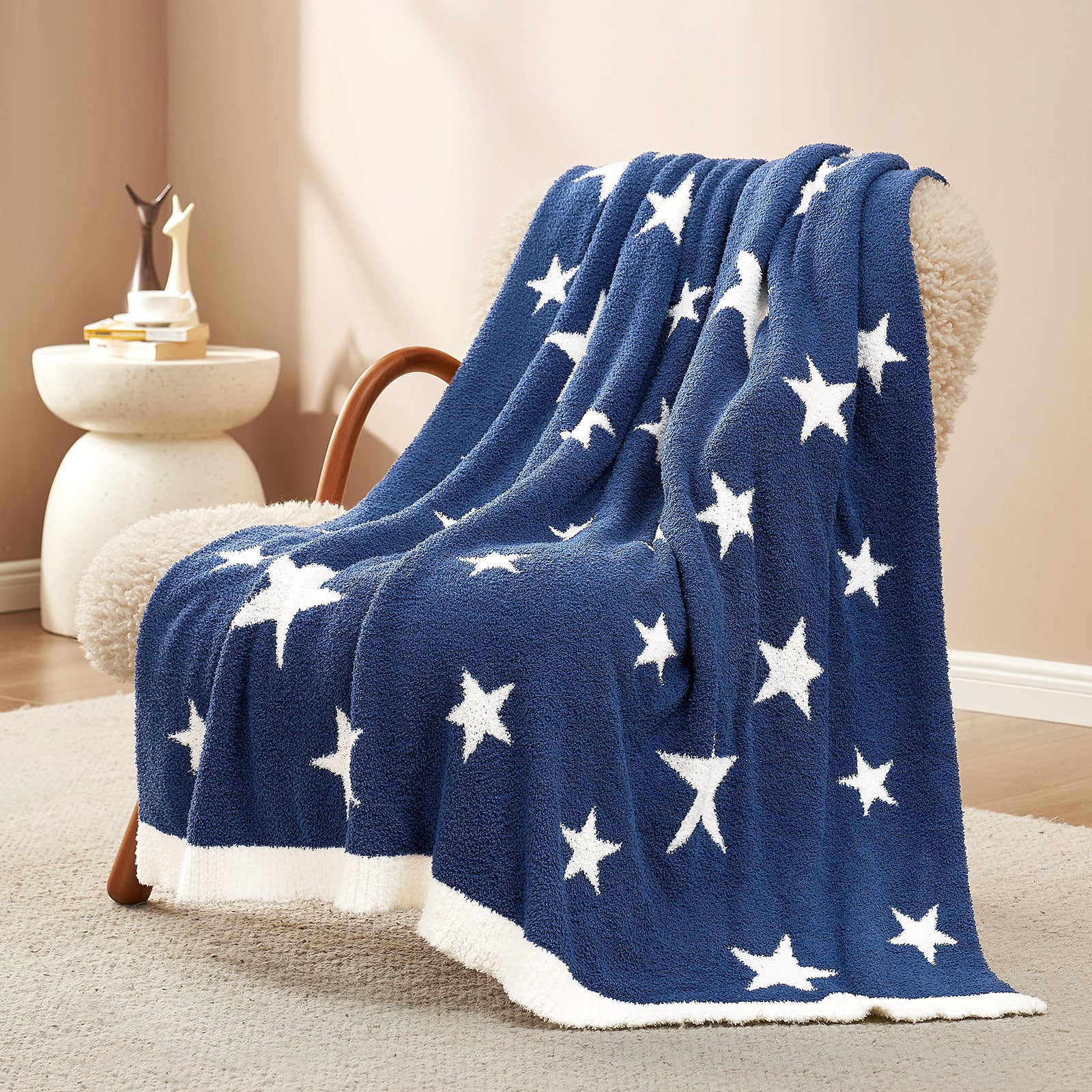 Snuggle Sacs Reversible Star Feather Yarn Knit Throw Blanket draped on a beige couch#color_Royal_Heather_Blue