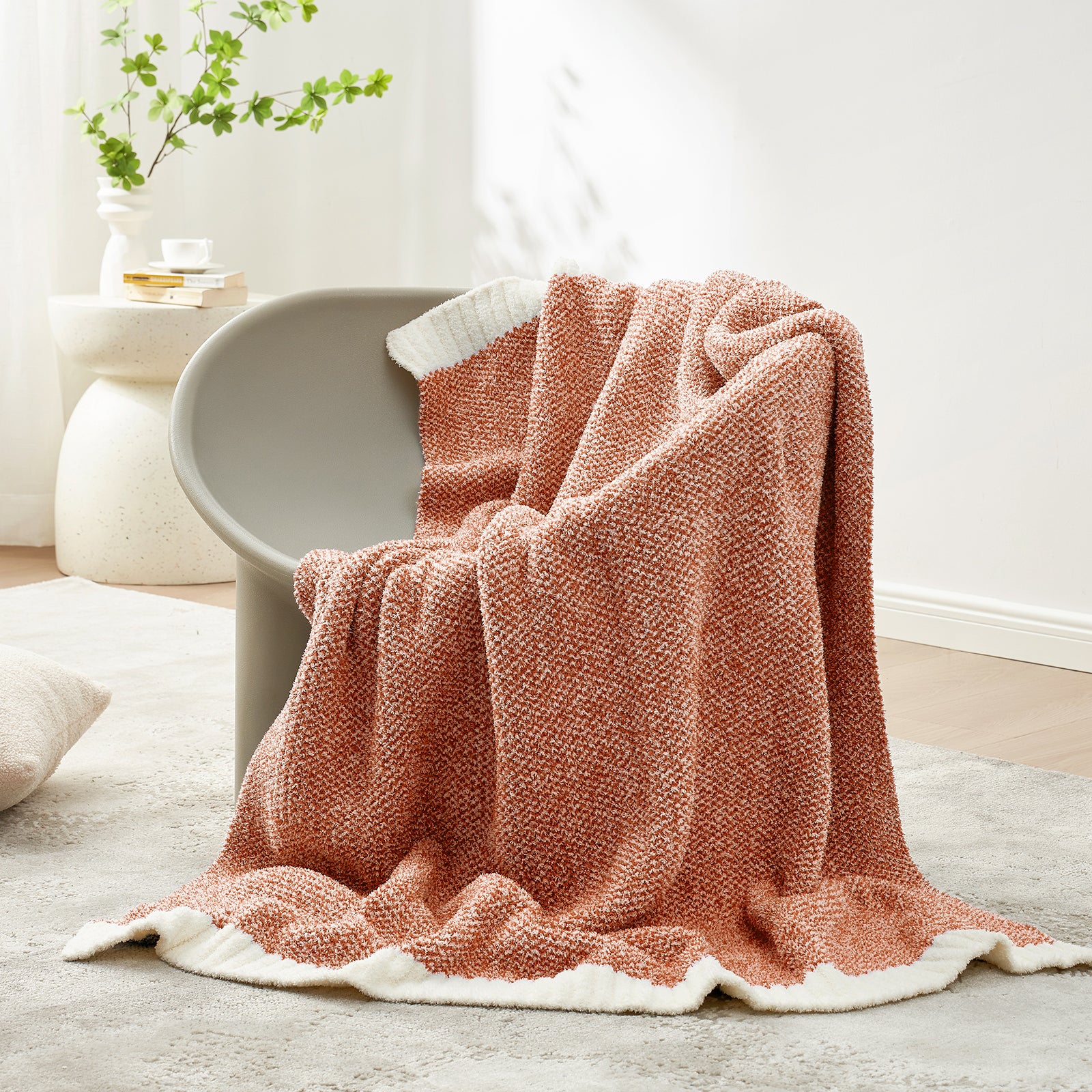 Snuggle Sac Heather Feather Yarn Orange Knit Throw Blanket on the chair#Color_Orange