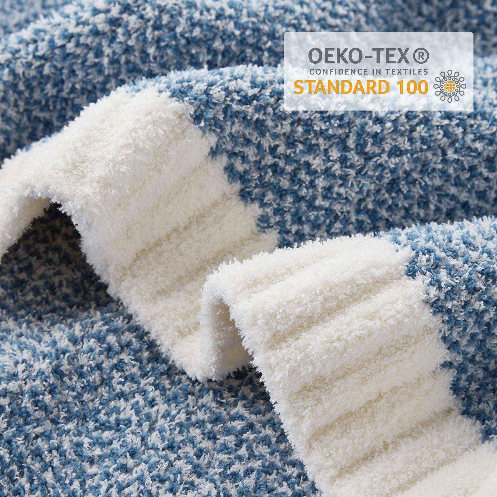 Close up of Snuggle Sac Heather Feather Yarn Pale Blue Knit Throw Blanket showing OEKO-TEX certificate#Color_Pale Blue