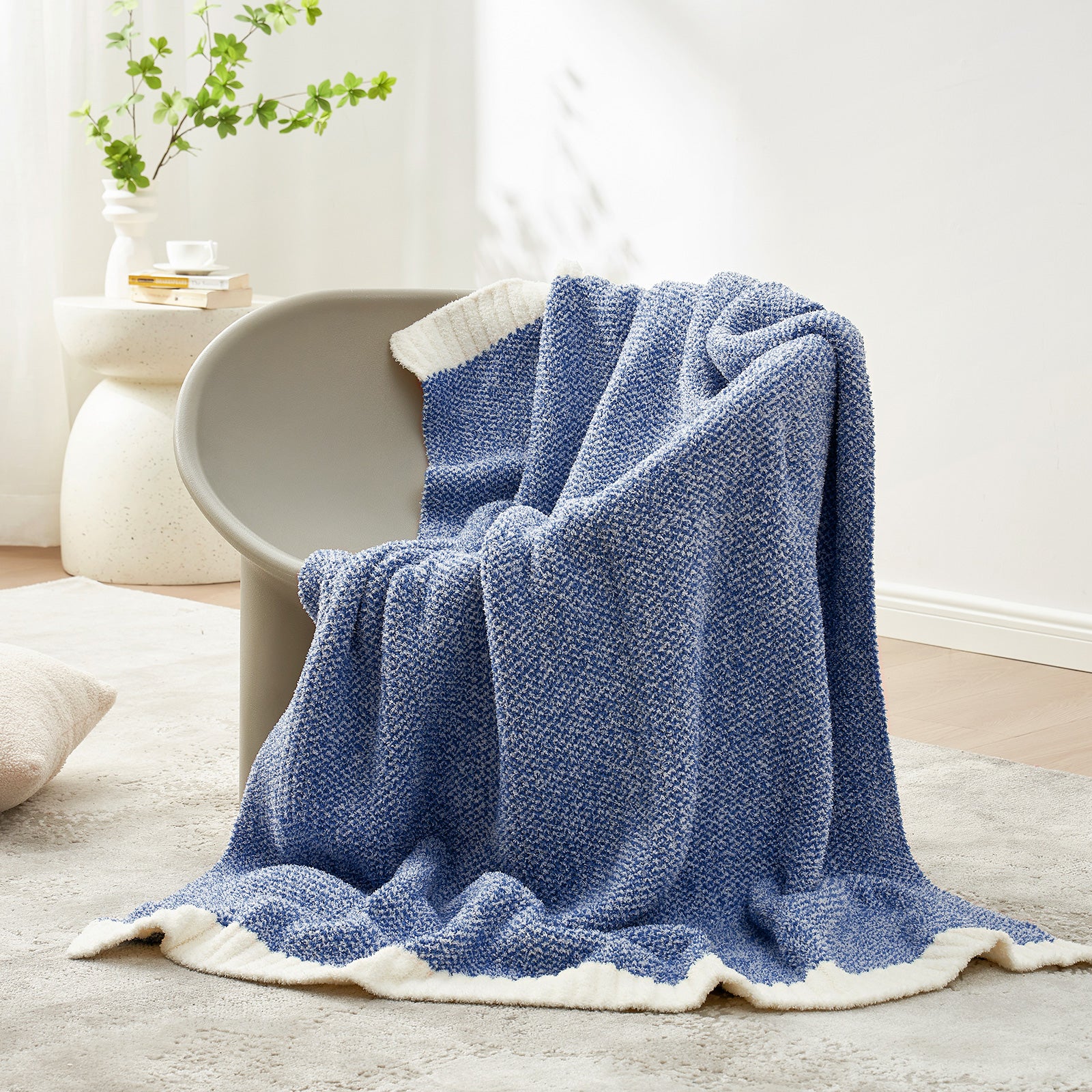 Snuggle Sac Heather Feather Yarn Heather Royal Blue Knit Throw Blanket on the chair#color_Heather Royal Blue