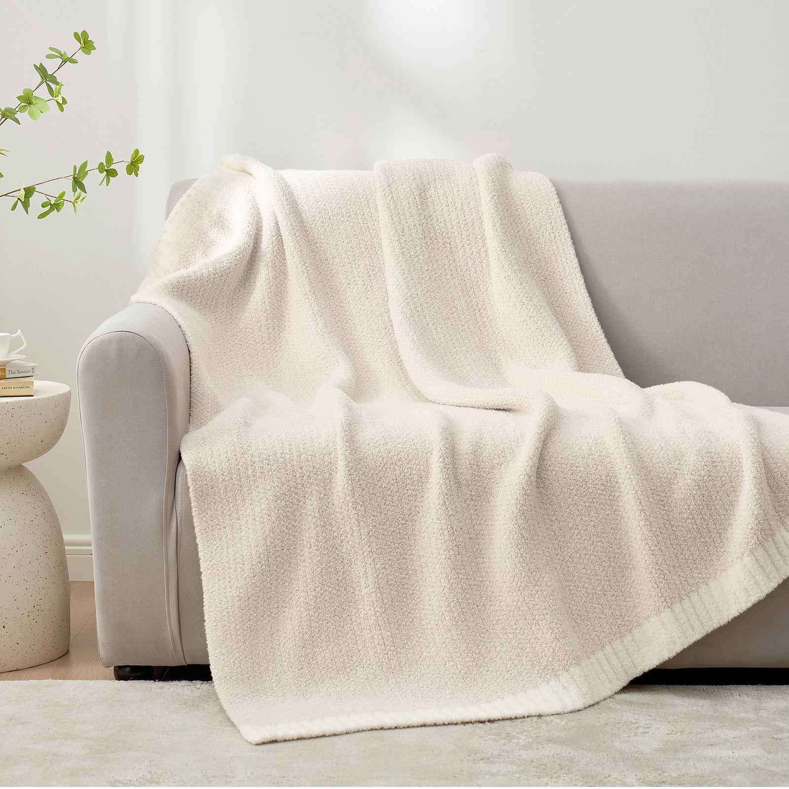 Snuggle Sac Heather Feather Yarn Ivory Knit Throw Blanket on the couch#Color_Ivory