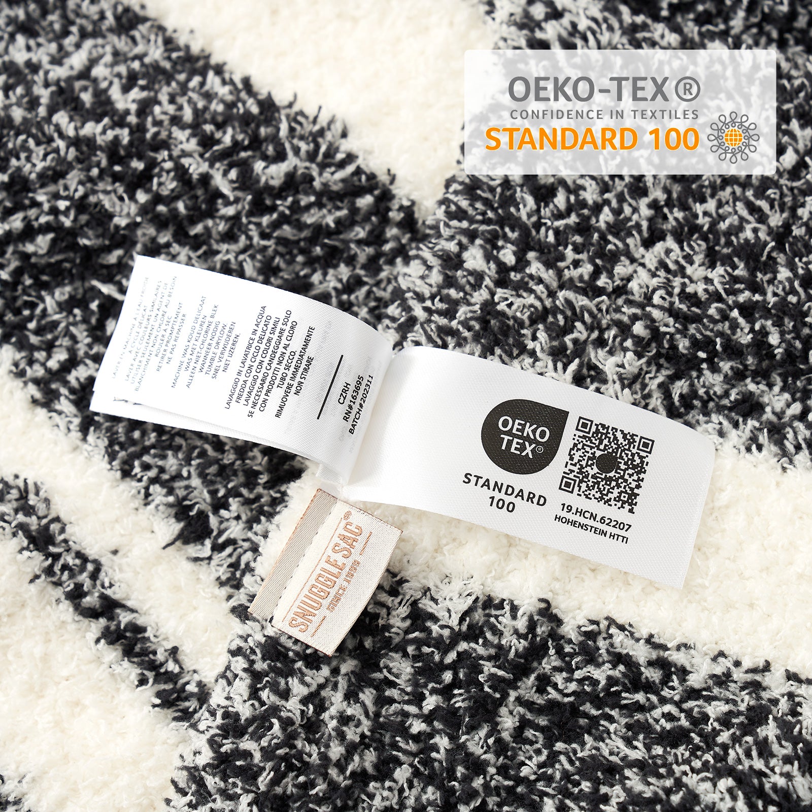 Close up of Striped Feather Yarn Knit Throw Blanket showing OEKO-TEX Certificate#Color_Black