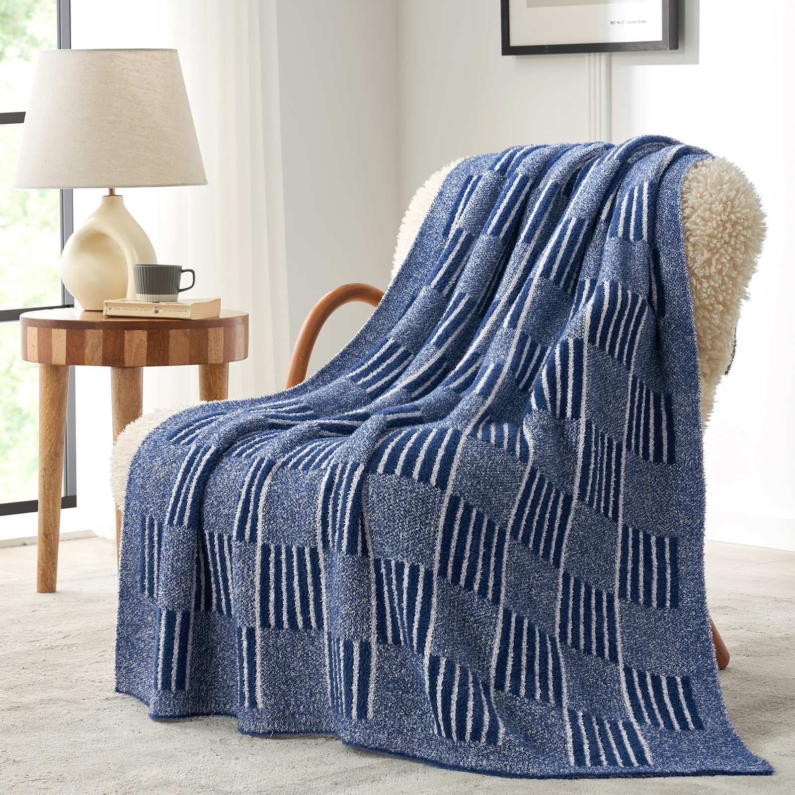 Snuggle Sacs Reversible Heather Checkered Feather Yarn Knit Throw Blanket draped on a beige chair#Color_Heather Navy