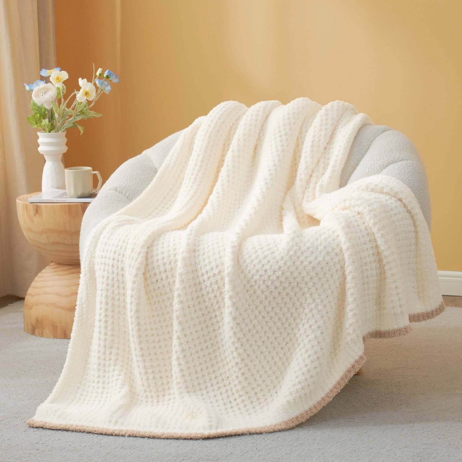 Soft Waffle Feather Yarn Knit Throw Blanket  draped over a beige sofa#Color_Cream
